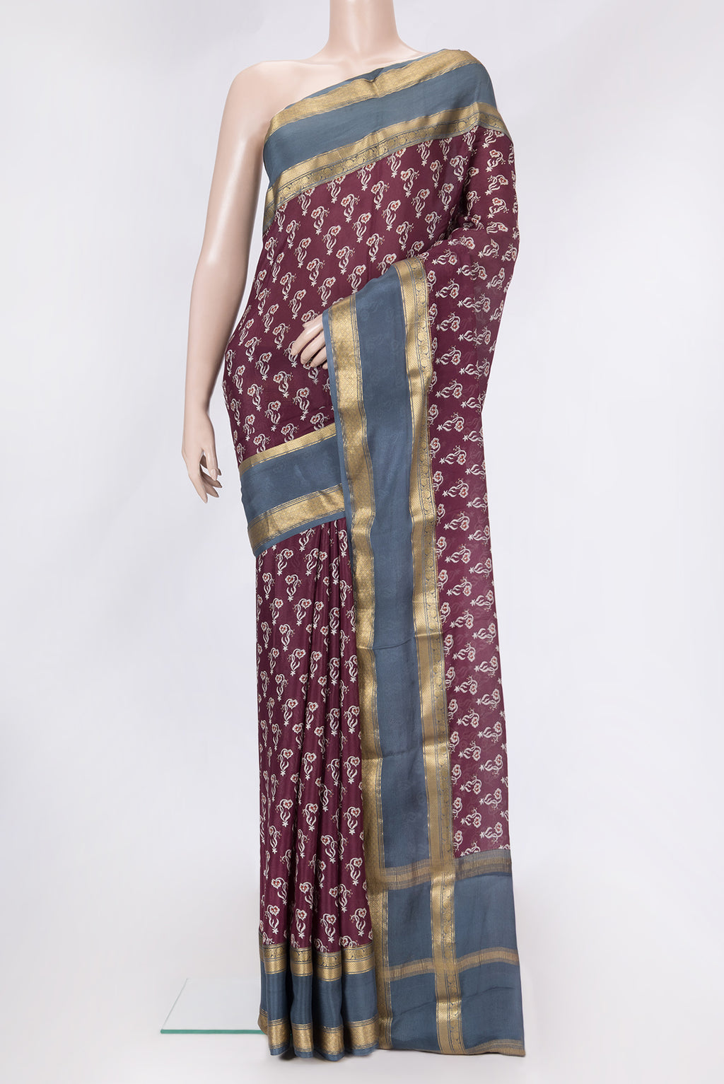 Maroon Dual Tone Mysore Crepe Saree with Printed design on the body and Zari Border.  displayed on a mannequin