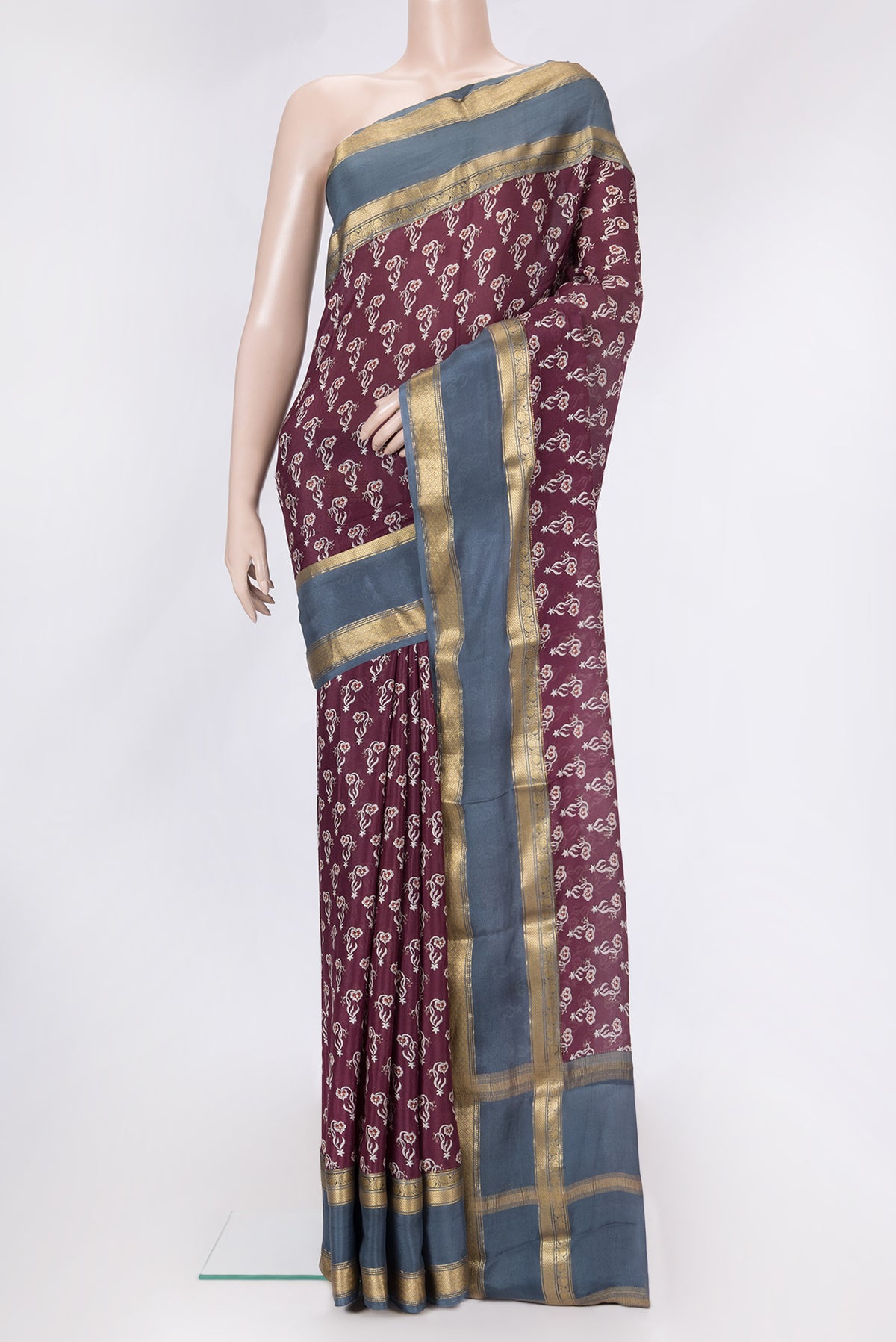 Maroon Dual Tone Mysore Crepe Saree with Printed design on the body and Zari Border.  displayed on a mannequin