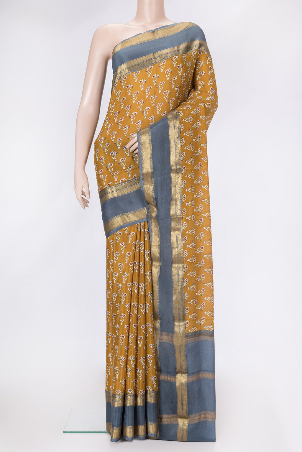 Mustard Dual Tone Mysore Crepe Saree with Printed design on the body and Zari Border.  displayed on a mannequin