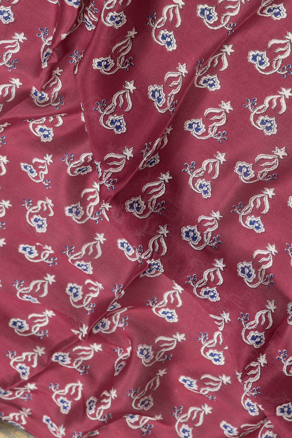 Close up of Maroon Dual Tone Mysore Crepe Saree with Printed design on the body and Zari Border.  displaying folds