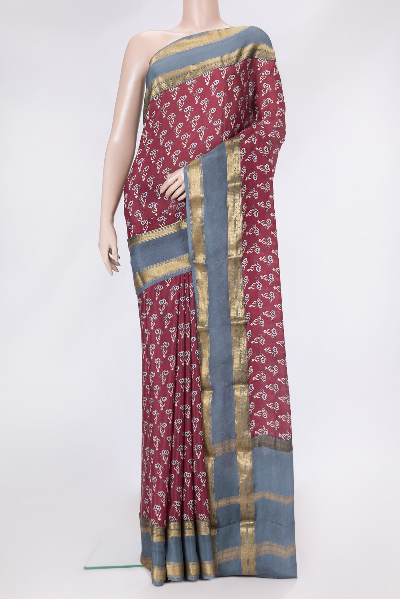 Maroon Dual Tone Mysore Crepe Saree with Printed design on the body and Zari Border.  displayed on a mannequin
