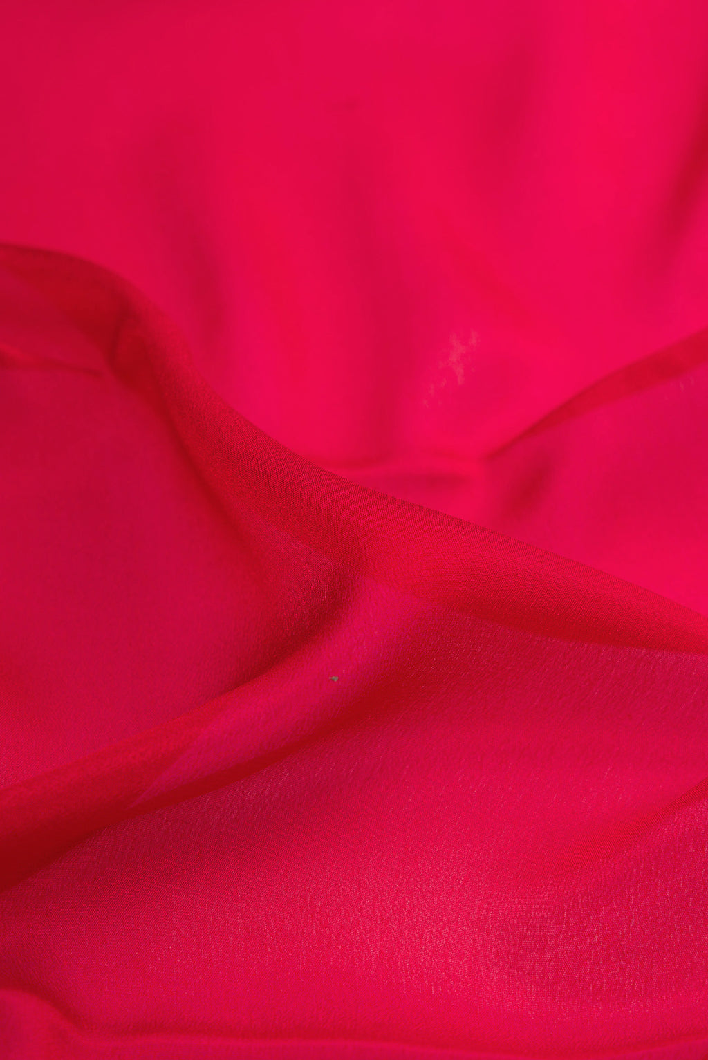 Close up of Red Dual Tone Mysore Crepe Saree with Plain Body and Zari Border.  displaying folds