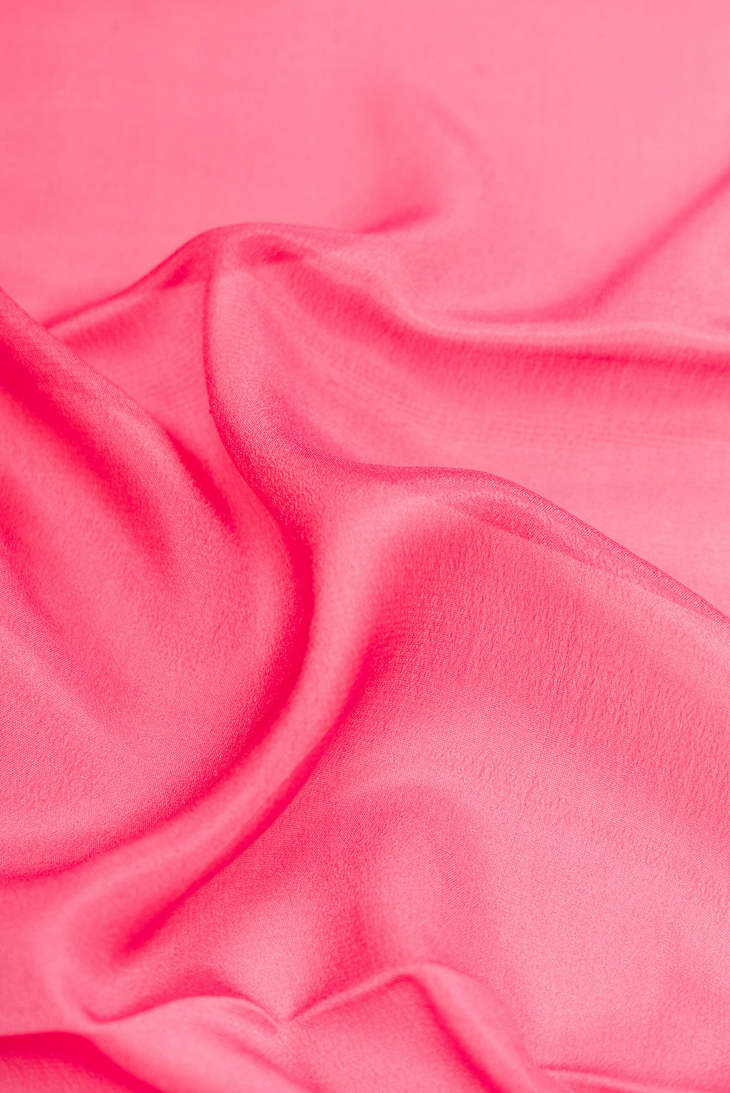 Close up of Pink Dual Tone Mysore Crepe Saree with Plain Body and Zari Border.  displaying folds