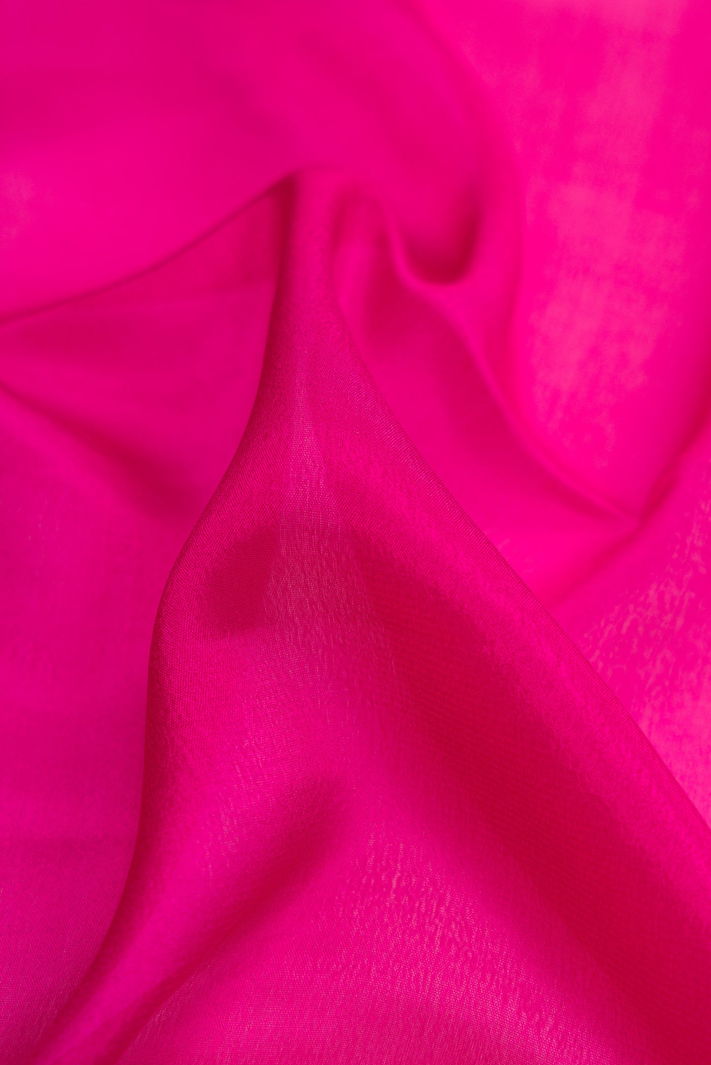 Close up of Dark Pink Dual Tone Mysore Georgette Saree with Plain Body and Zari Border.  displaying folds