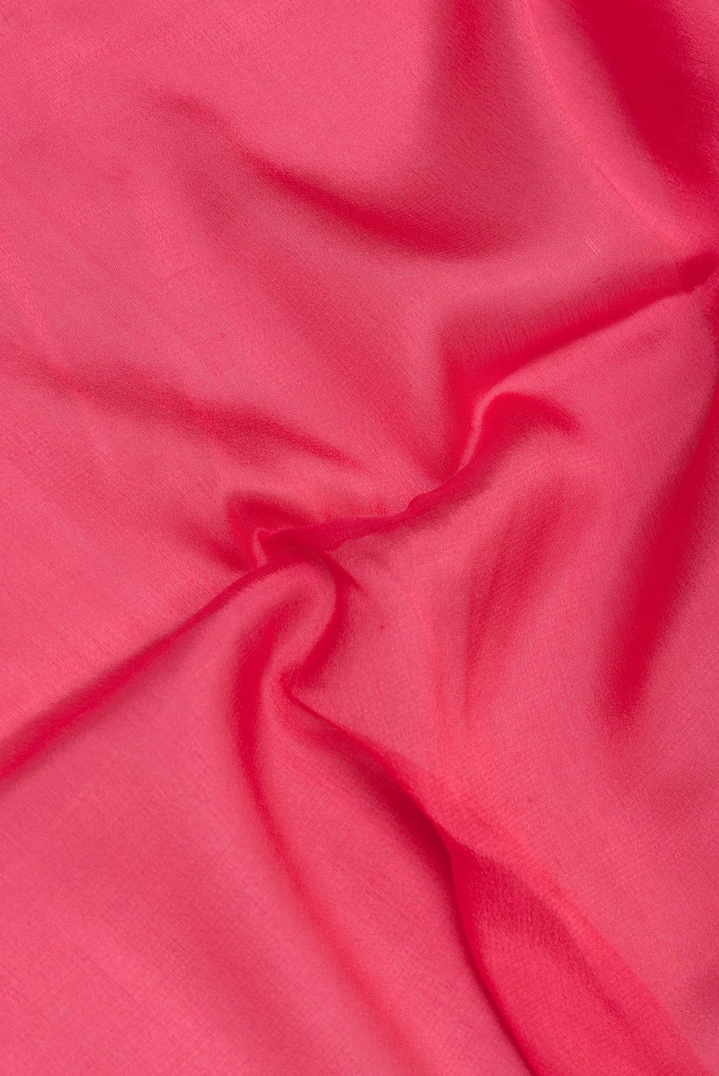 Close up of Pink Dual Tone Georgette Saree with Plain Body and Zari Border.  displaying folds