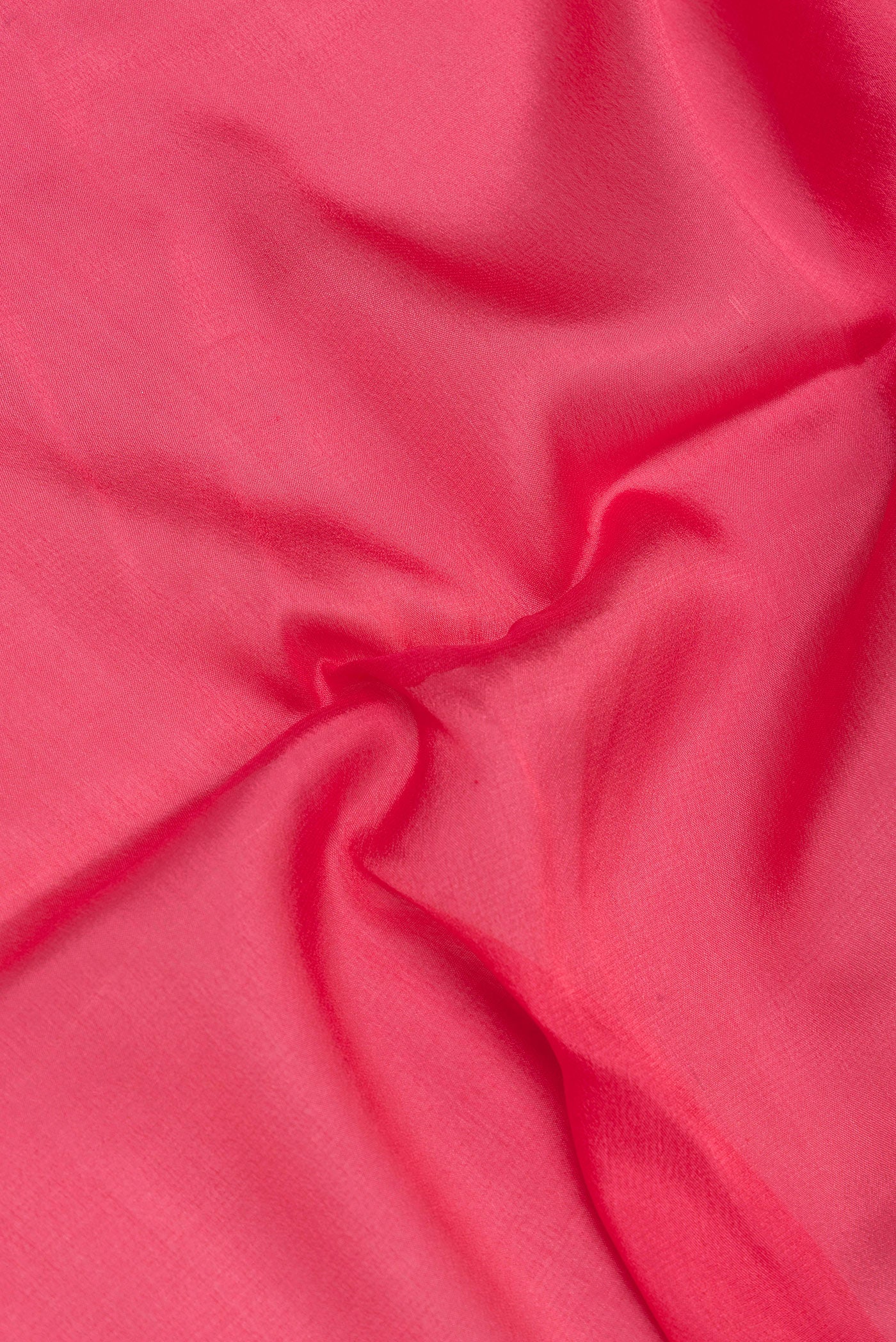 Close up of Pink Dual Tone Georgette Saree with Plain Body and Zari Border.  displaying folds