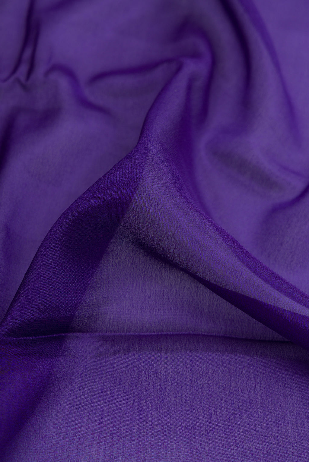 Close up of Navy Blue Dual Tone Mysore Georgette Saree with Plain Body and Zari Border.  displaying folds