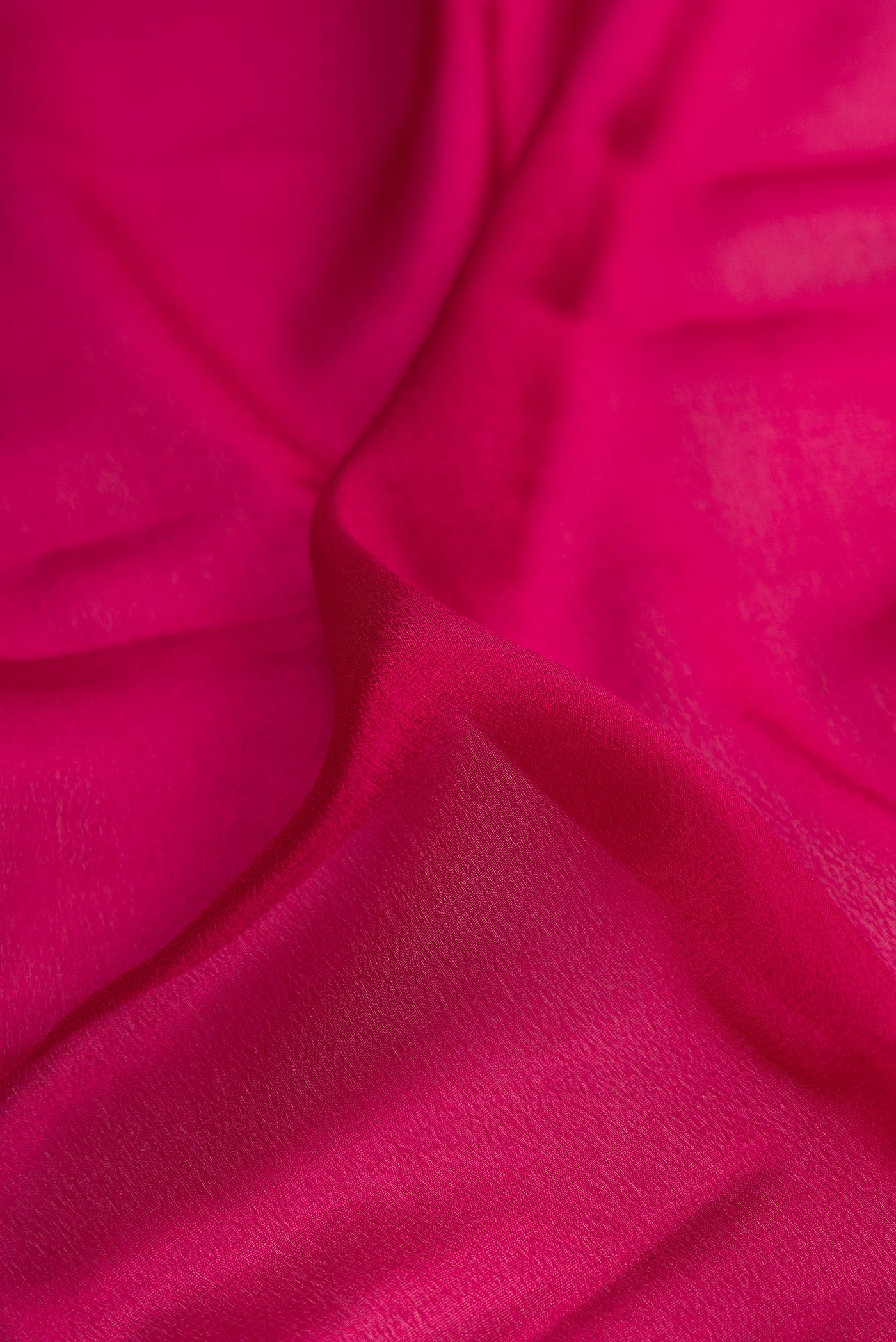 Close up of Maroon Dual Tone Mysore Crepe Saree with Plain Body and Zari Border.  displaying folds