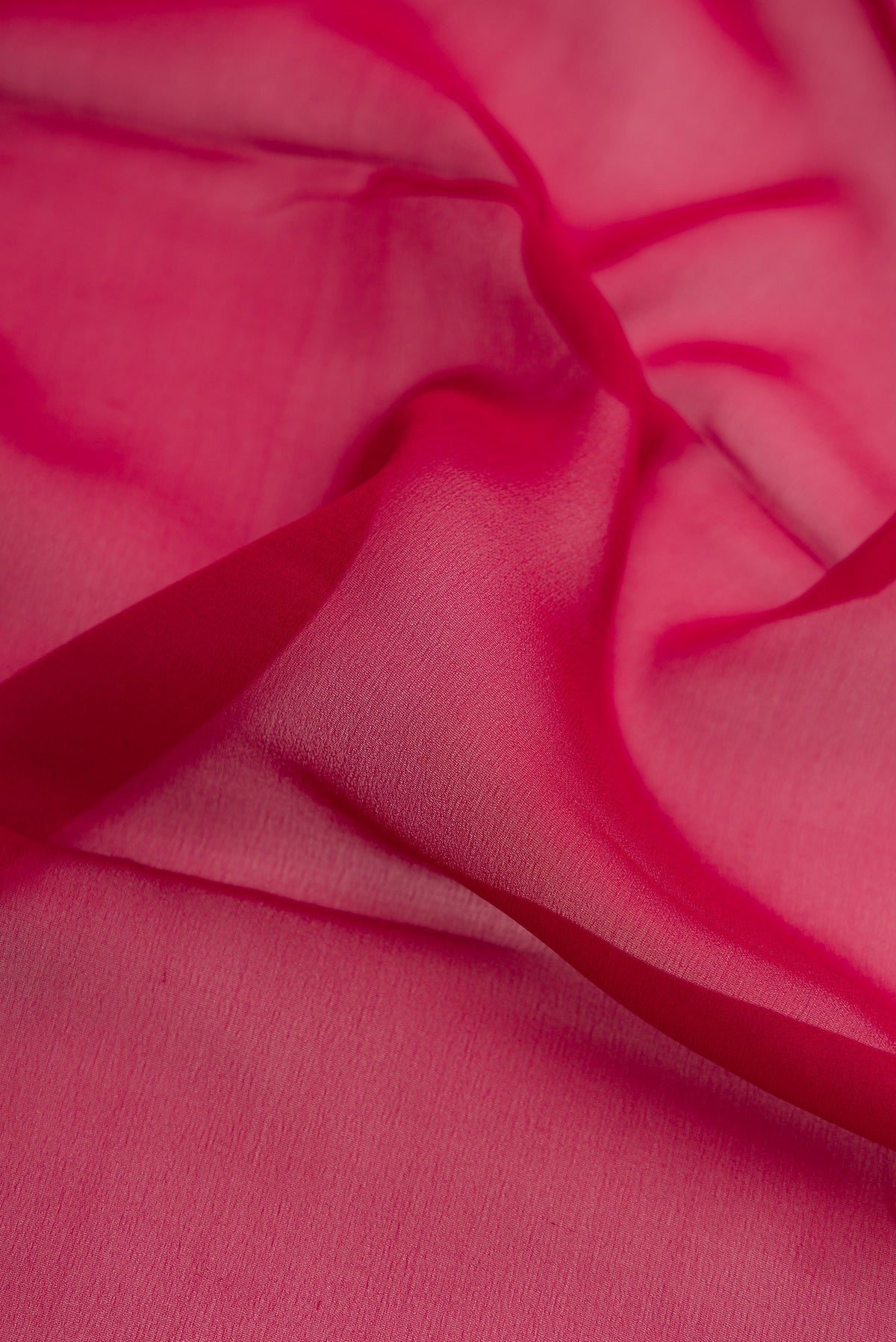 Close up of Maroon Dual Tone Mysore Georgette Saree with Plain Body and Zari Border.  displaying folds
