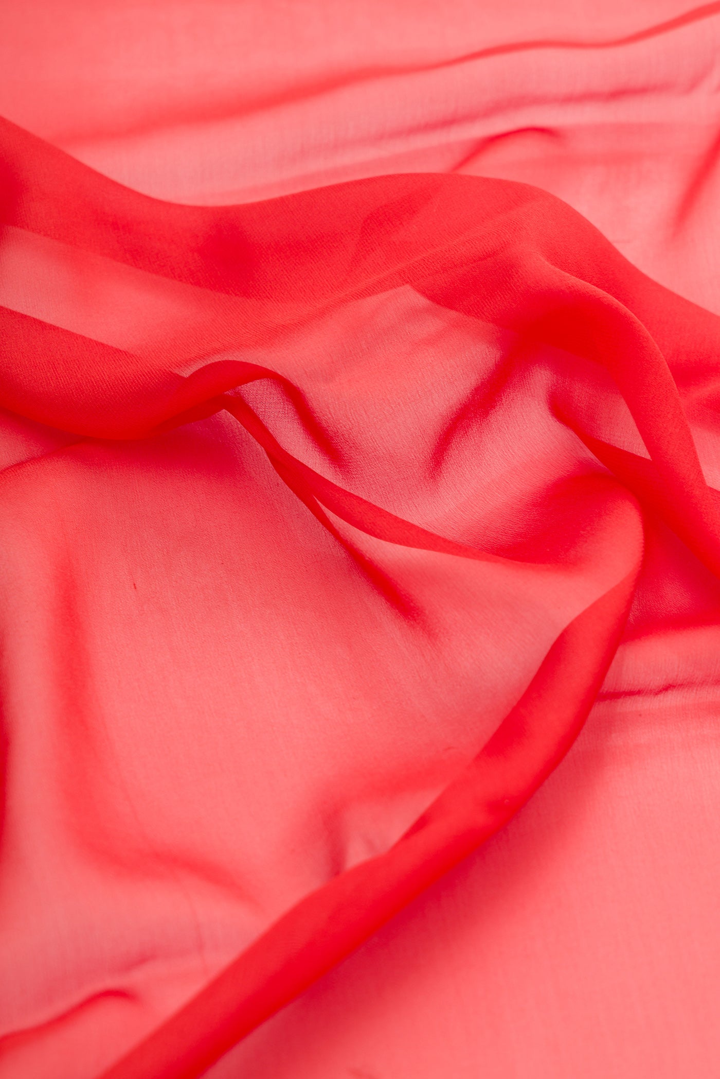 Close up of Orange Dual Tone Mysore Georgette Saree with Plain Body and Zari Border.  displaying folds