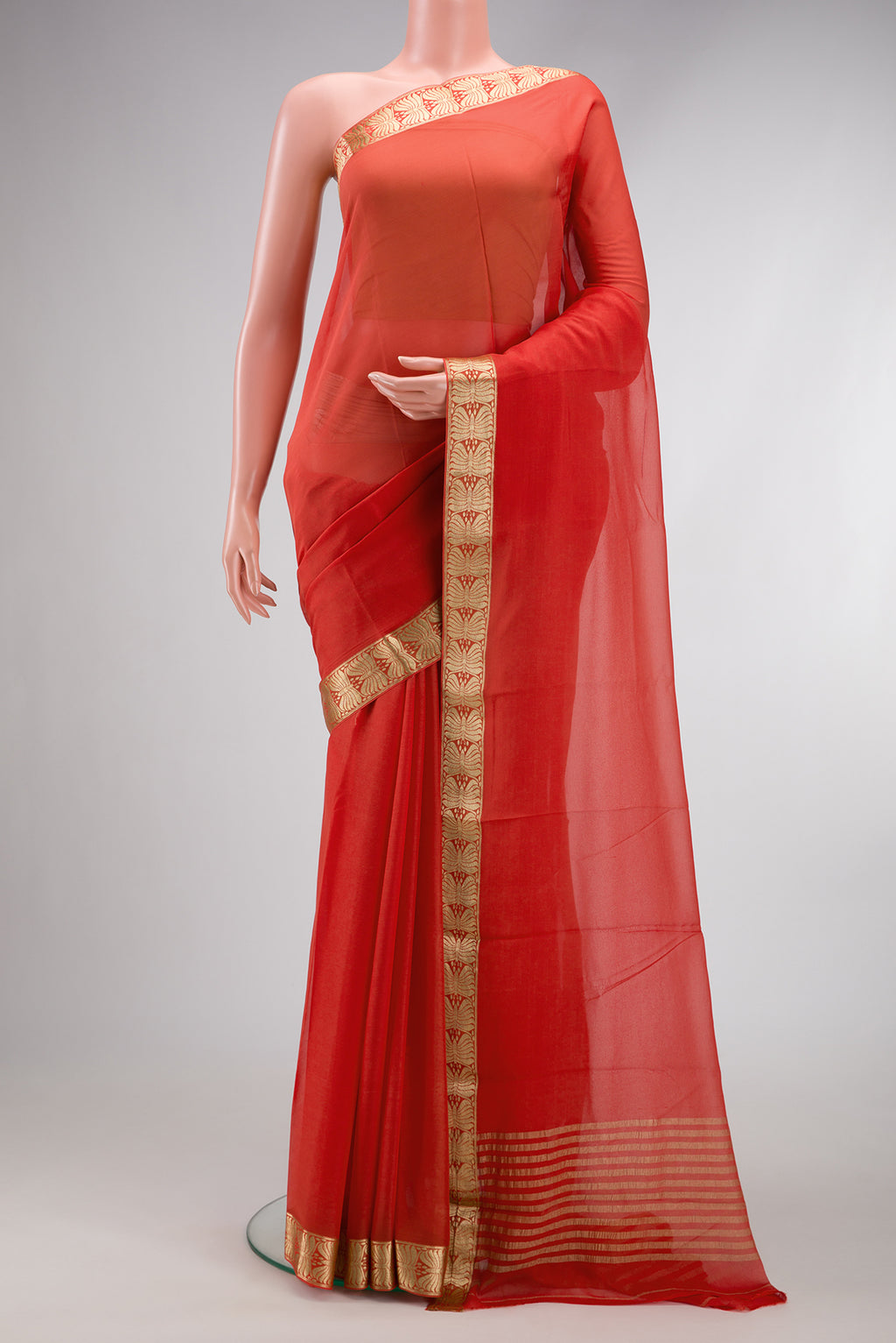 Orange Dual Tone Mysore Georgette Saree with Plain Body and Zari Border.  displayed on a mannequin