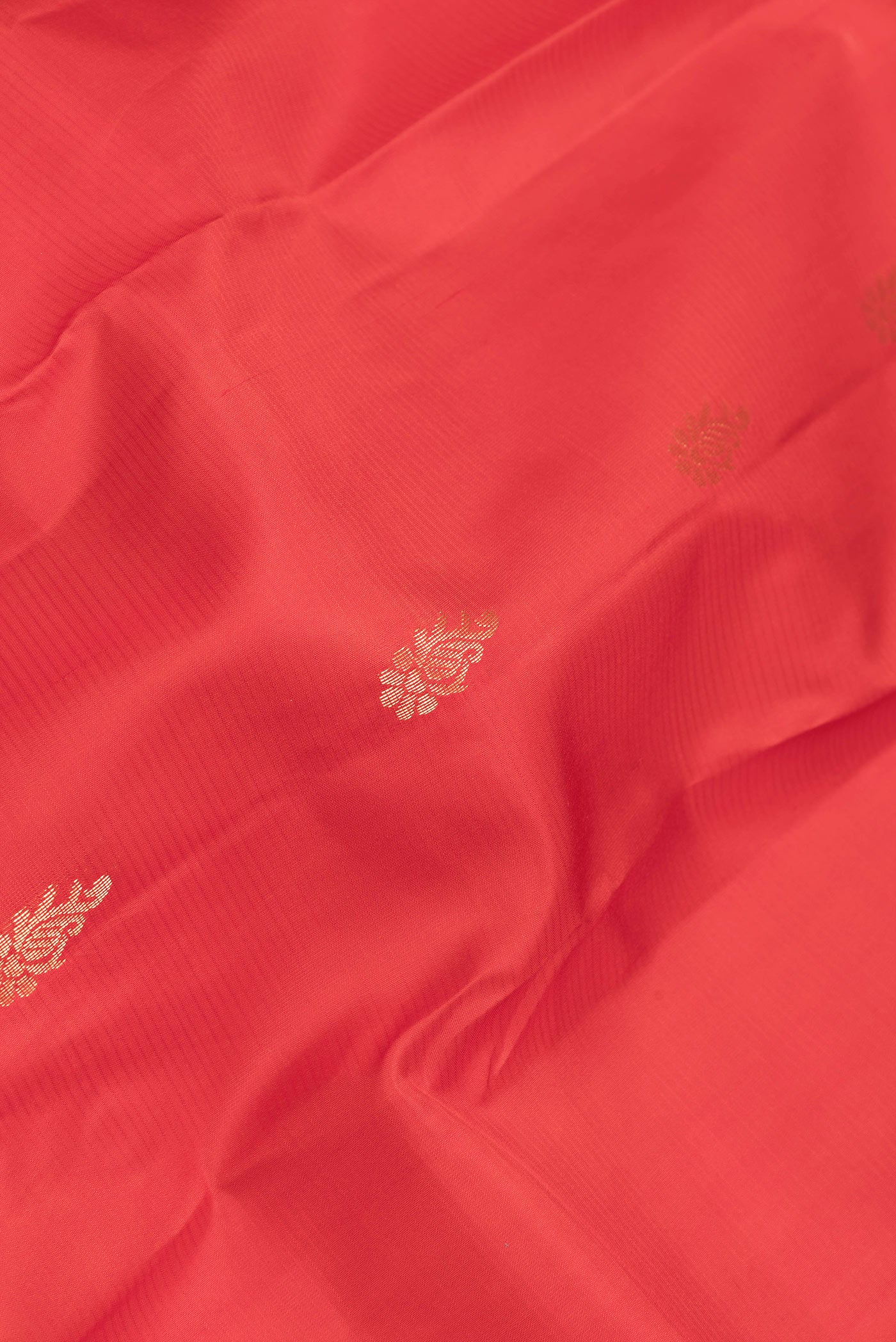 Close up of Red Dual Tone Kanjivaram Silk Saree with Zari Butta on the body and Zari Border.  displaying folds