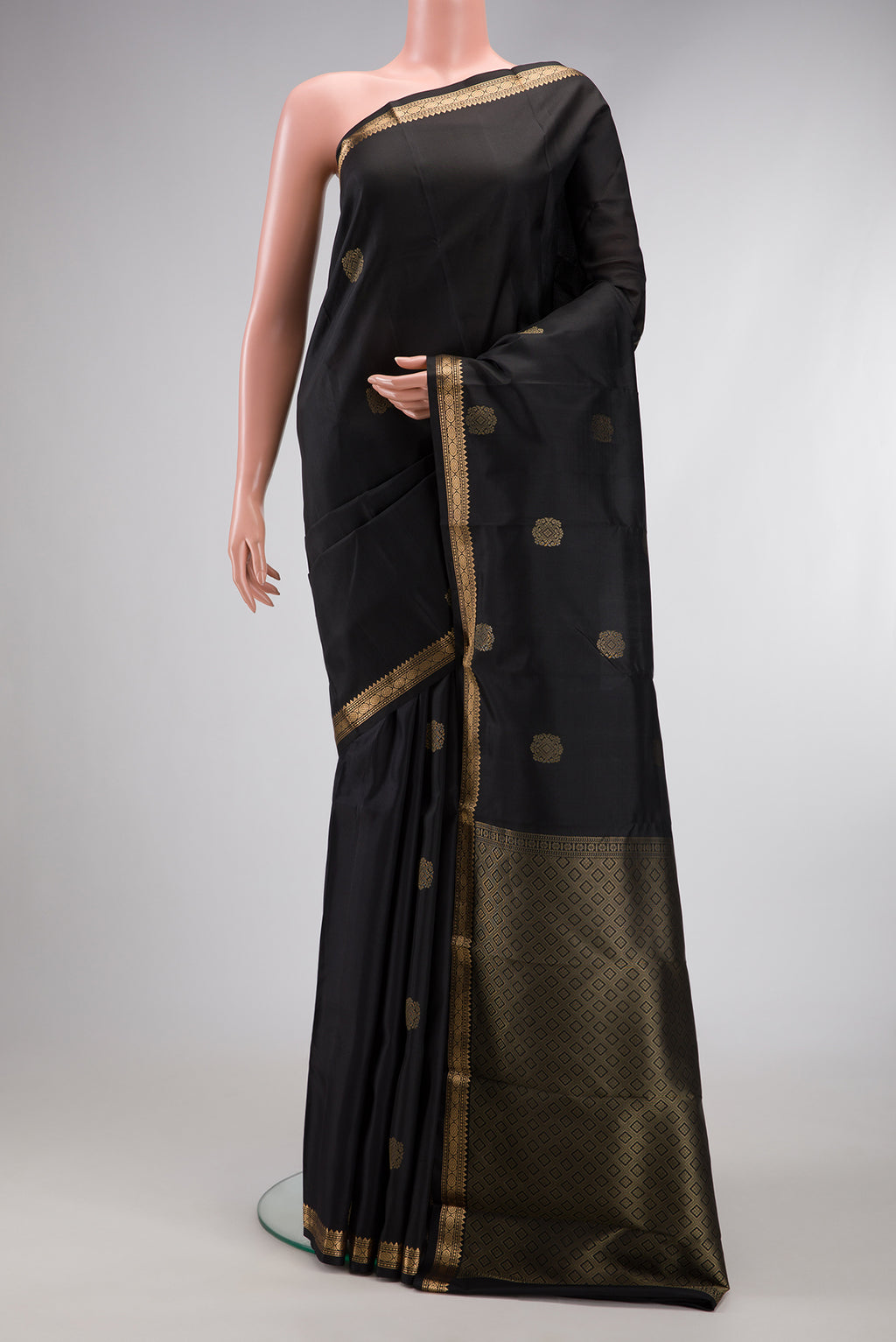 Black Dual Tone Kanjivaram Silk Saree with Zari Butta on the body and Zari Border.  displayed on a mannequin