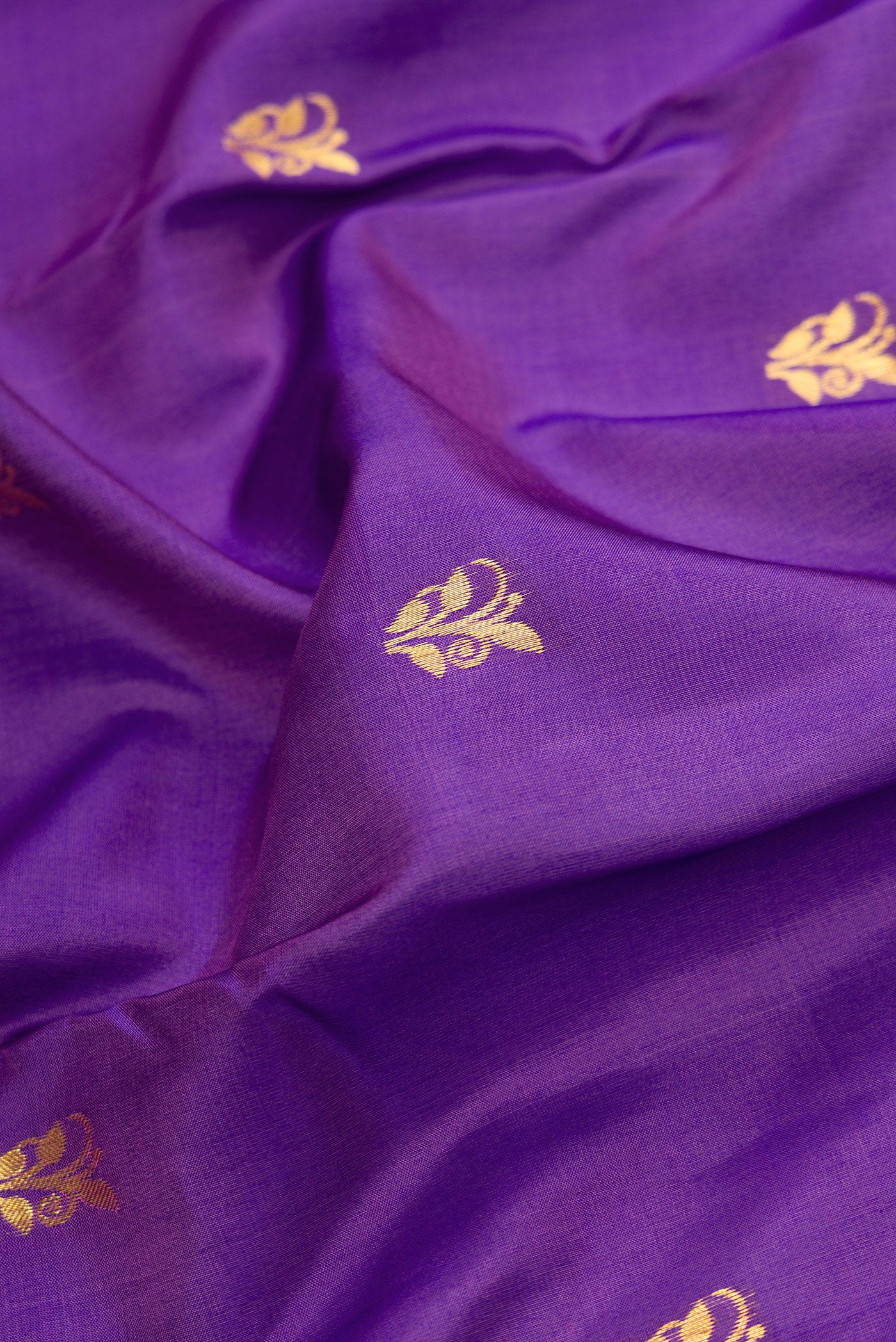 Close up of Purple Dual Tone Kanjivaram Silk Saree with Zari Butta on the body and Zari Border.  displaying folds