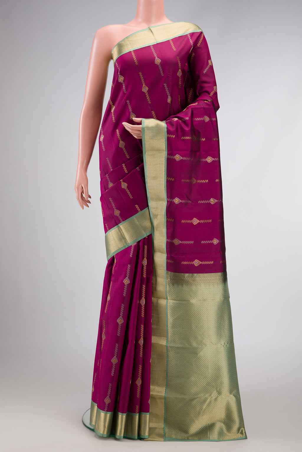 Magenta Dual Tone Kanchipuram Silk Saree with Zari Butta on the body and Zari Border.  displayed on a mannequin