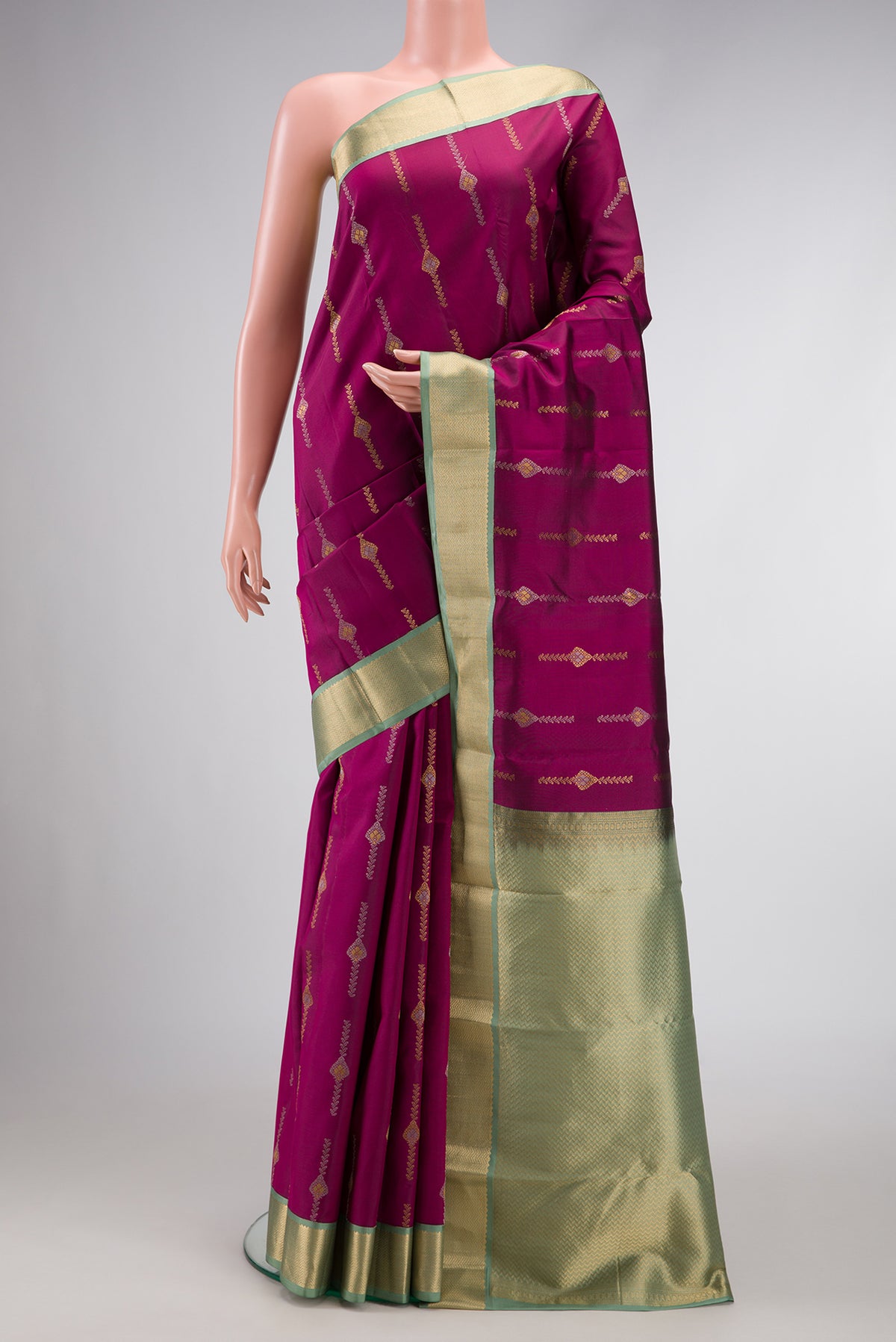 Magenta Dual Tone Kanchipuram Silk Saree with Zari Butta on the body and Zari Border.  displayed on a mannequin