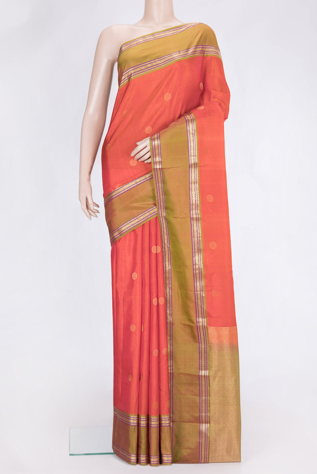 Orange Dual Tone Kanchipuram Silk Saree with Zari Butta on the body and Zari Border.  displayed on a mannequin