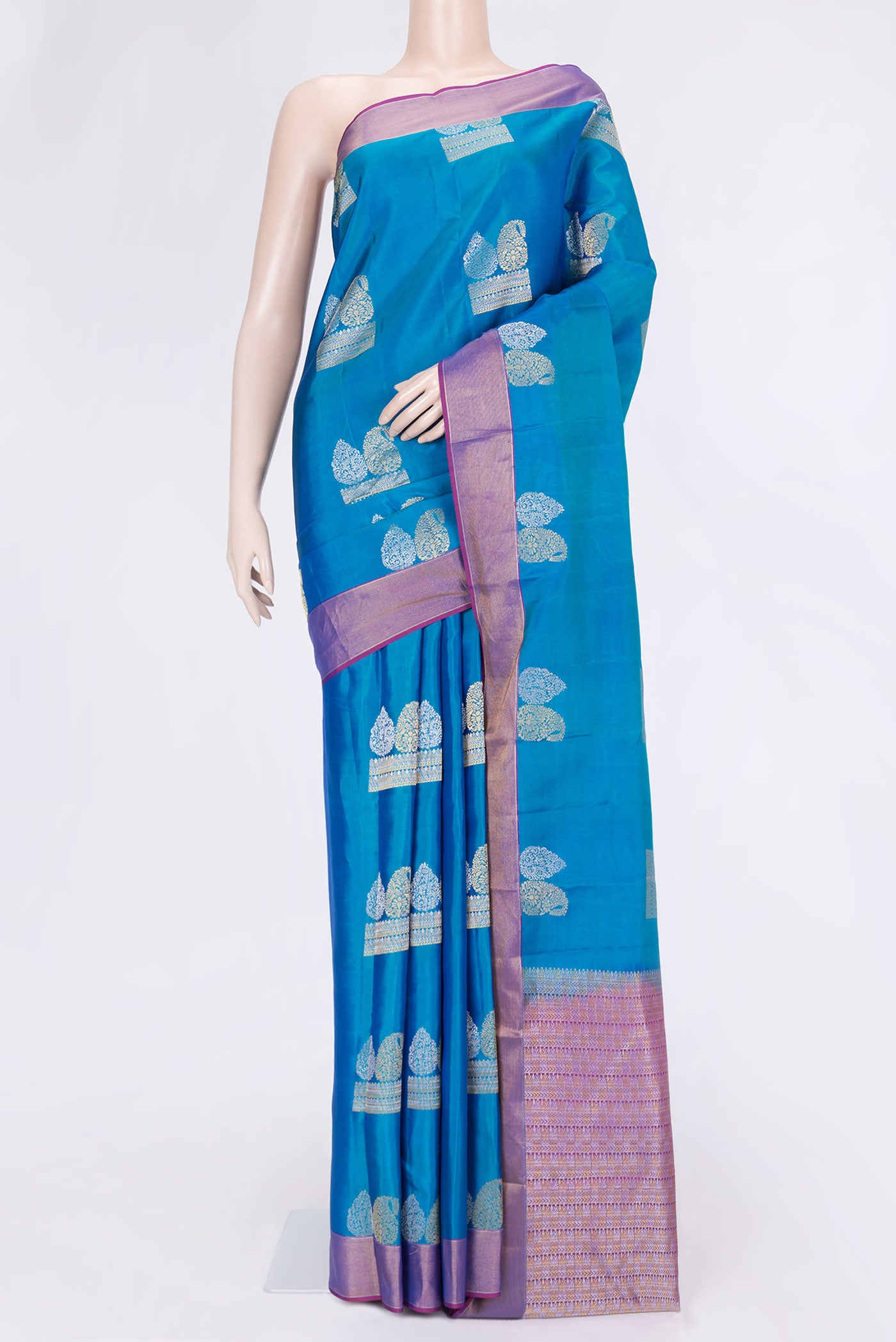 Peacock Blue Dual Tone Kanchipuram Silk Saree with Zari Butta on the body and Zari Border.  displayed on a mannequin