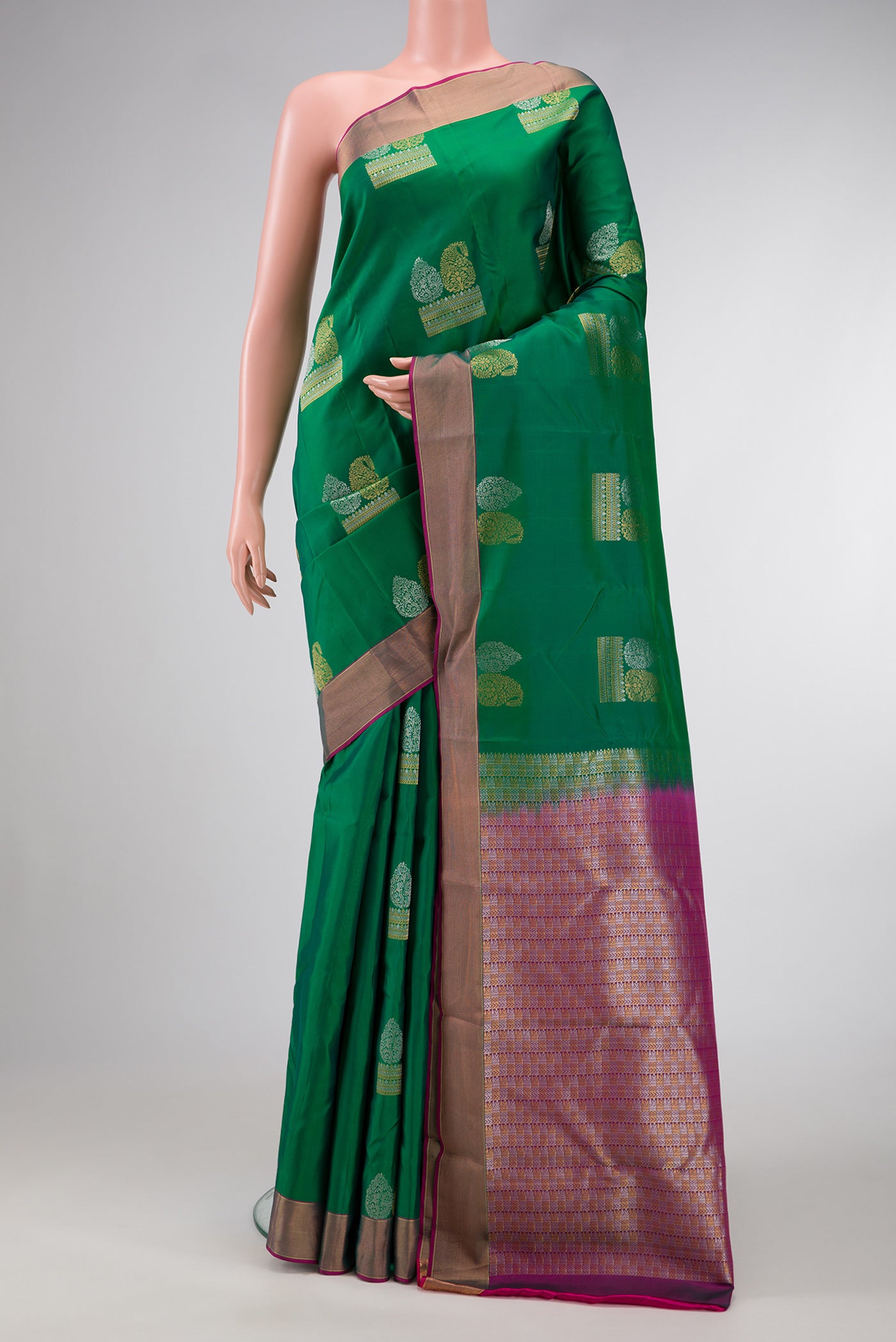 Green Dual Tone Kanchipuram Silk Saree with Zari Butta on the body and Zari Border.  displayed on a mannequin