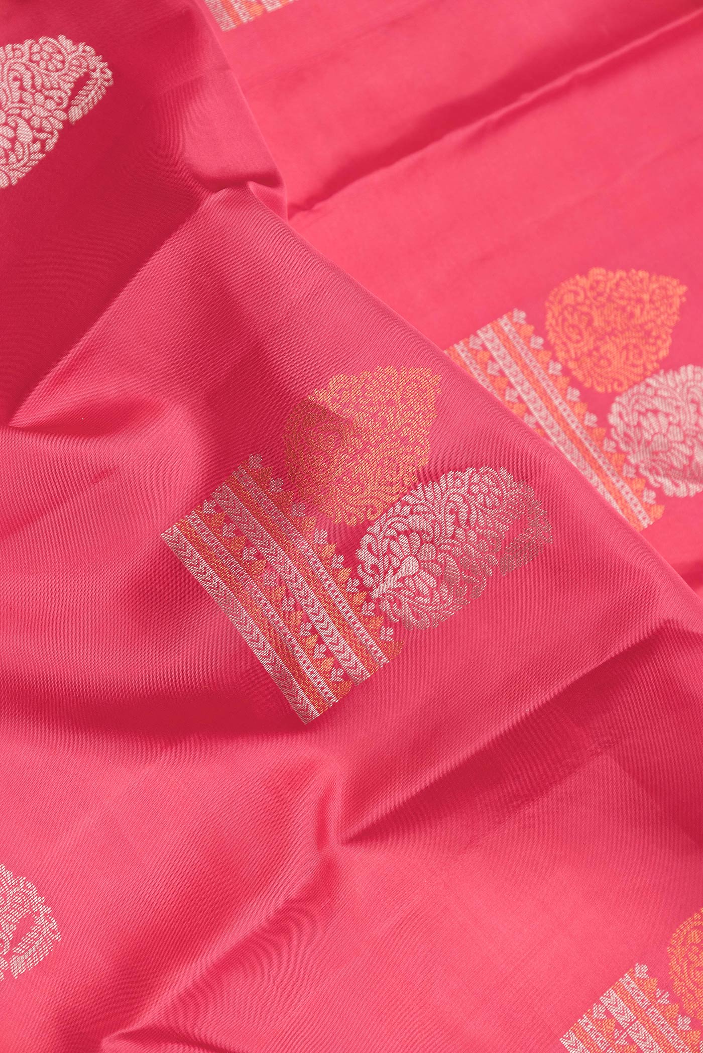 Close up of Pink Dual Tone Kanchipuram Silk Saree with Zari Butta on the body and Zari Border.  displaying folds