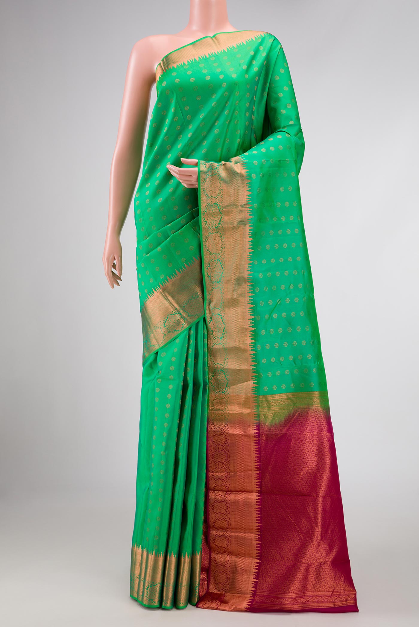 Green Dual Tone Kanchipuram Silk Saree with Zari Butta on the body and Zari Border displayed on a mannequin