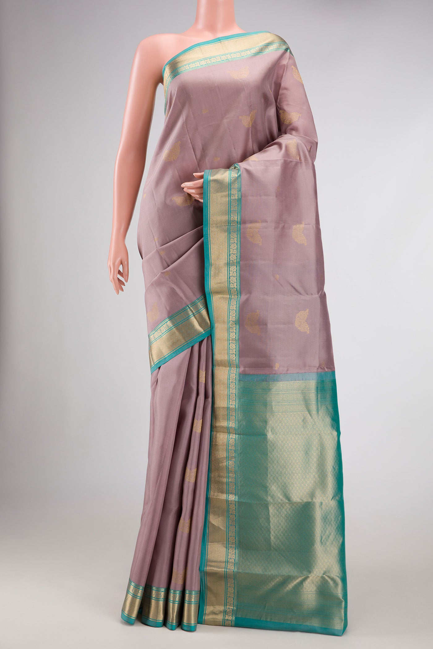 Rose Gold Dual Tone Kanchipuram Silk Saree with Zari Butta on the body and Zari Border.  displayed on a mannequin