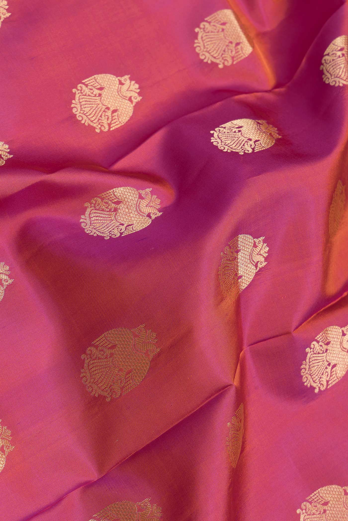 Close up of Pink Dual Tone Kanchipuram Silk Saree with Zari Butta on the body and Zari Border.  displaying folds