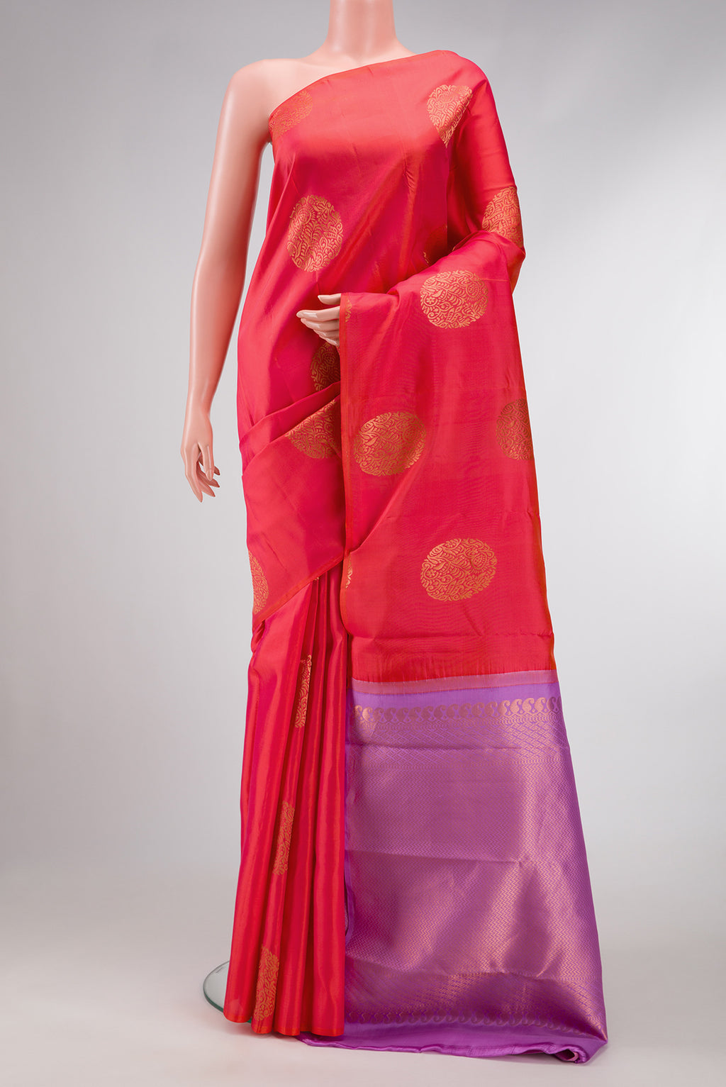 Orange Dual Tone Kanjivaram Silk Saree with Zari Butta on the body and Without Border.  displayed on a mannequin