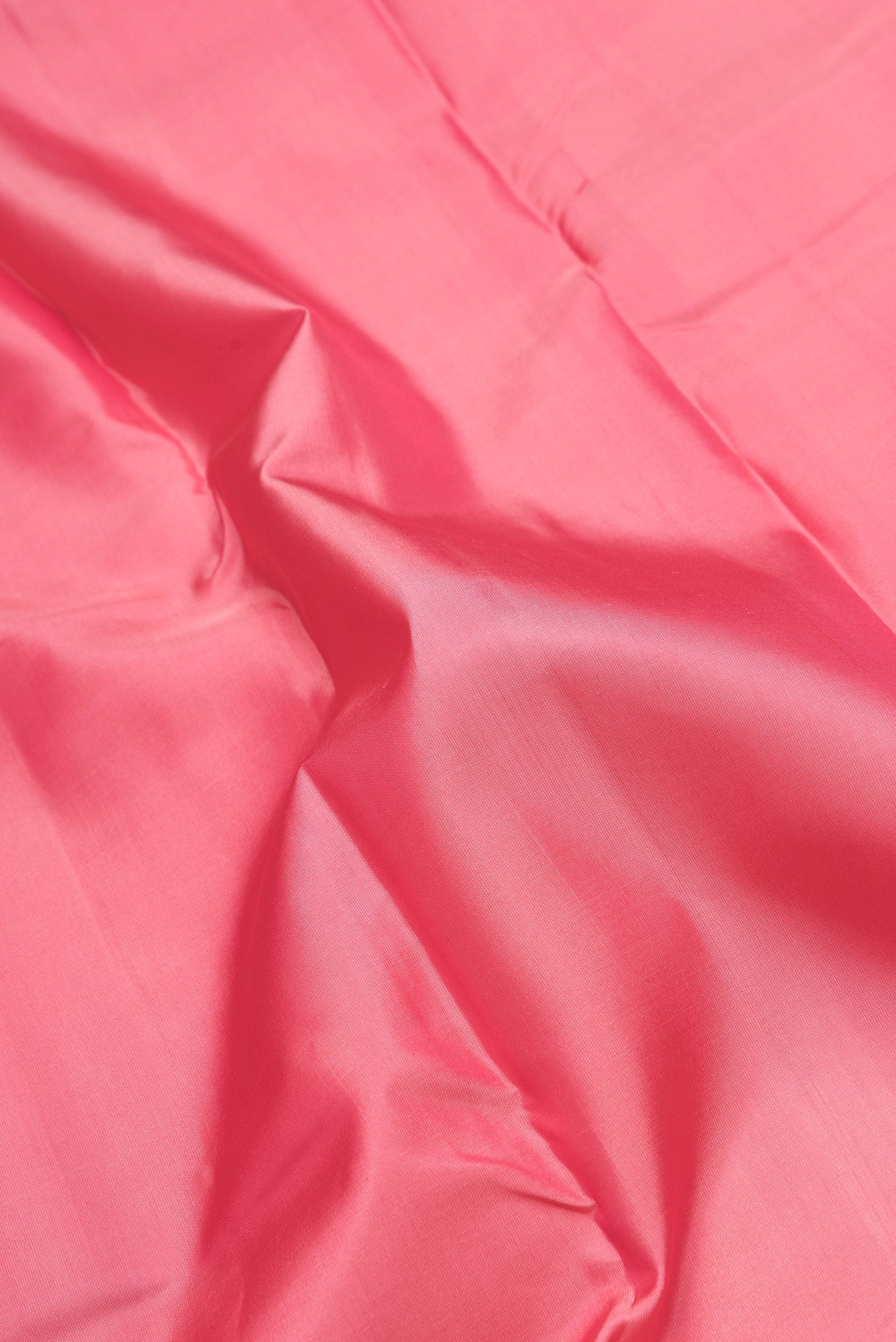 Close up of Pink Dual Tone Kanchipuram Silk Saree with Plain Body and Zari Border.  displaying folds
