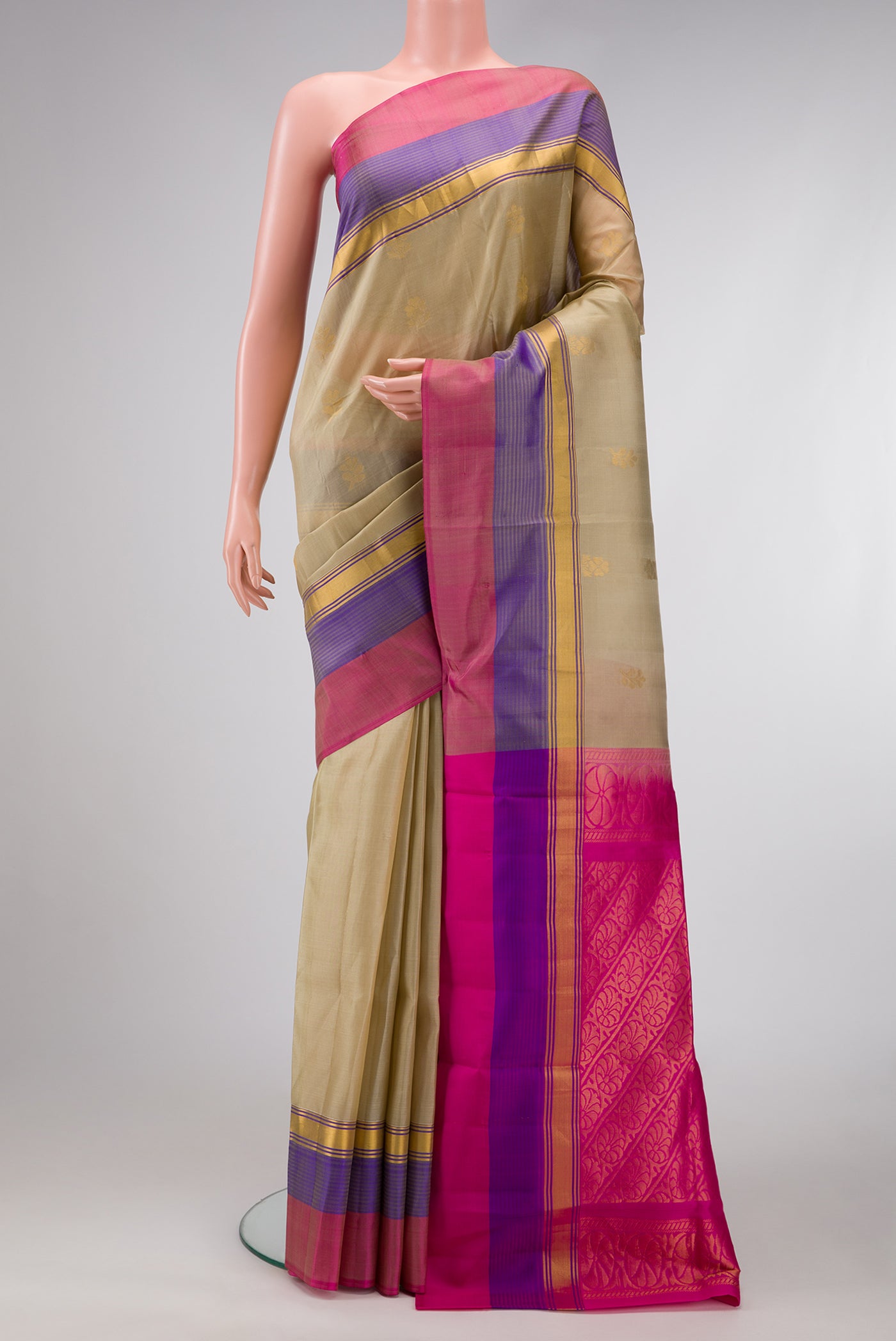 Beige Dual Tone Soft Silk Saree with Zari Butta on the body and Zari Border.  displayed on a mannequin