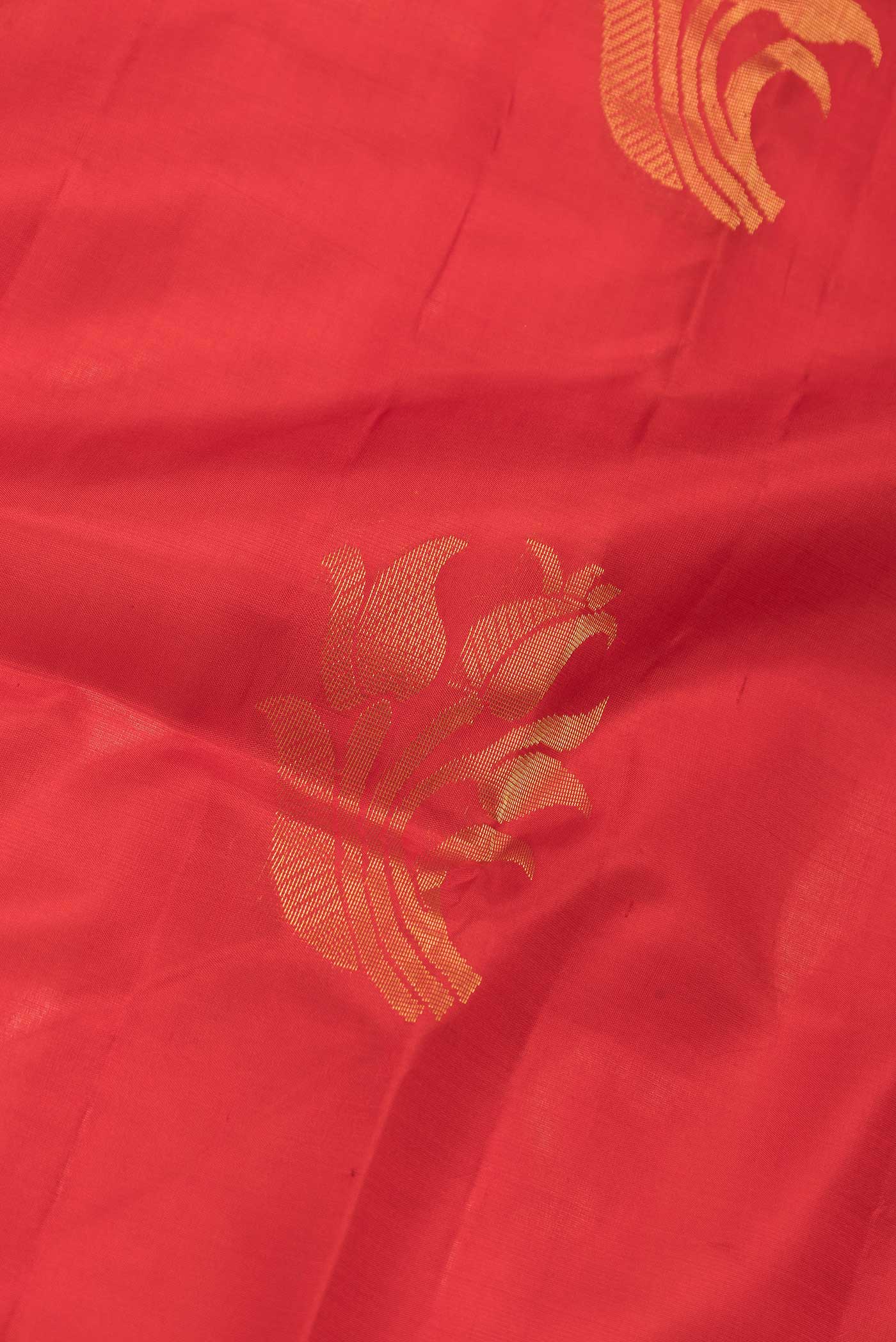 Close up of Red Dual Tone Soft Silk Saree with Zari Butta on the body and Zari Border.  displaying folds