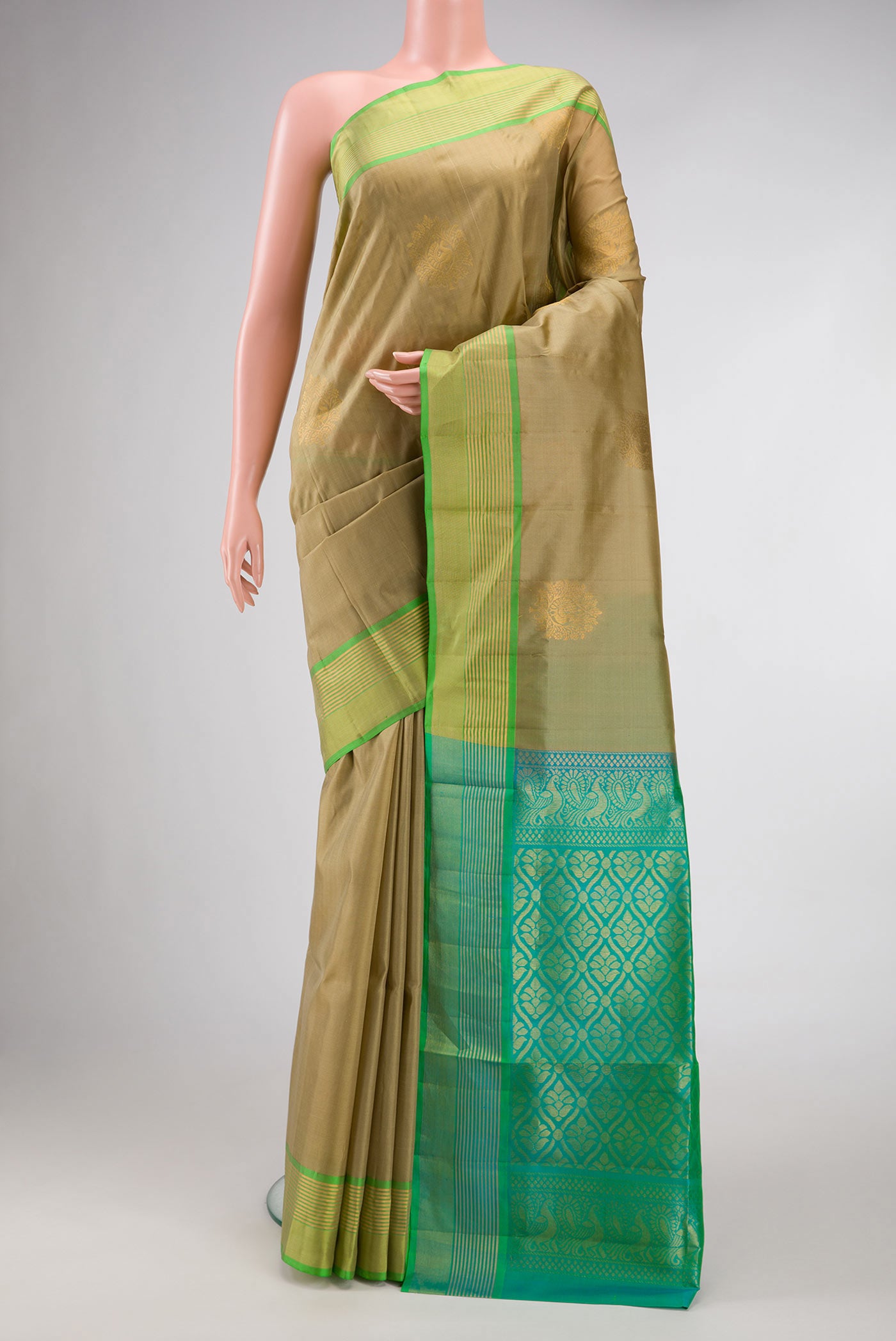 Mehandi Green Dual Tone Soft Silk Saree with Zari Butta on the body and Zari Border.  displayed on a mannequin