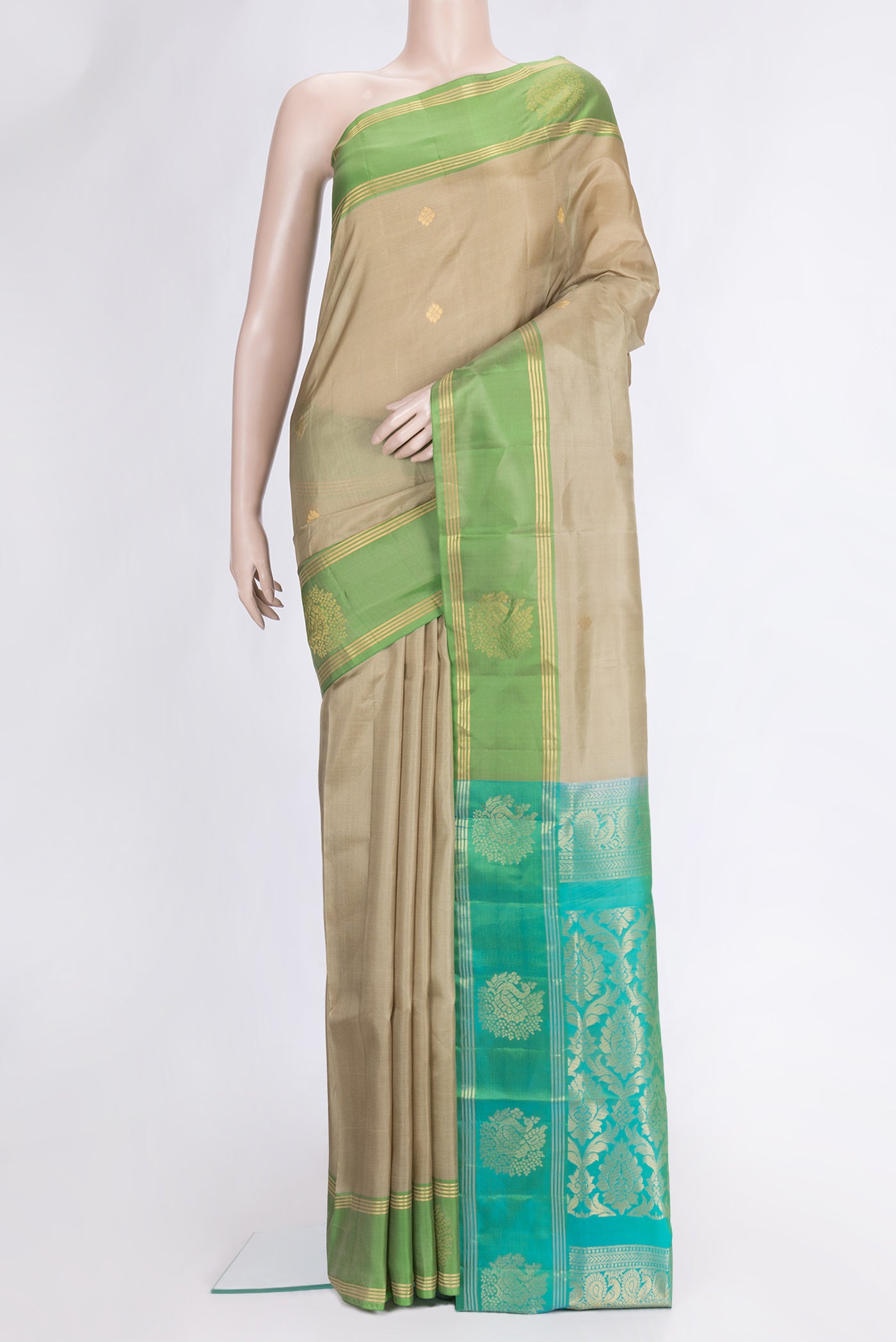 Pista Green Dual Tone Soft Silk Saree with Zari Butta on the body and Fancy Border.  displayed on a mannequin