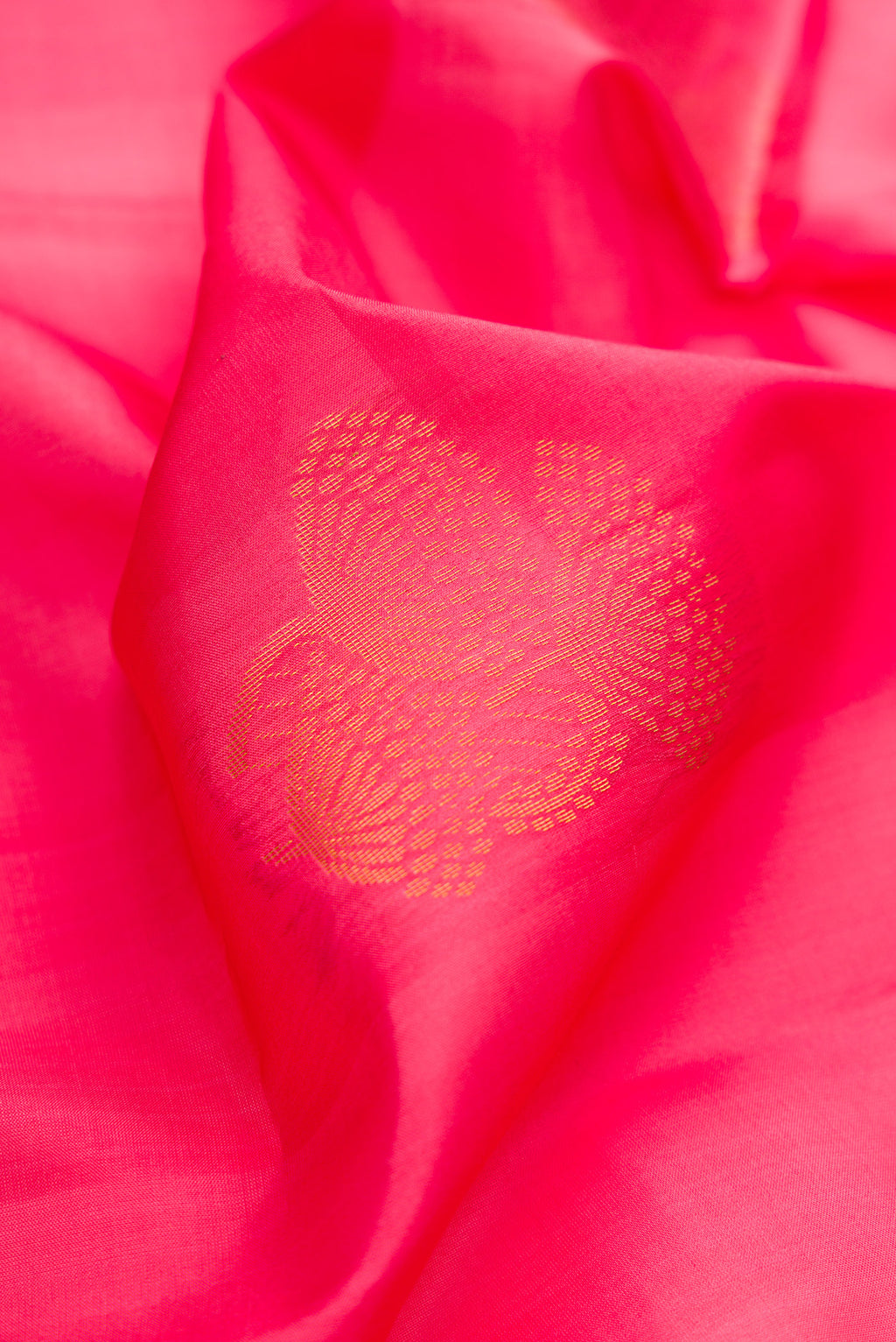 Close up of Pink Dual Tone Soft Silk Saree with Zari Butta on the body and Zari Border.  displaying folds
