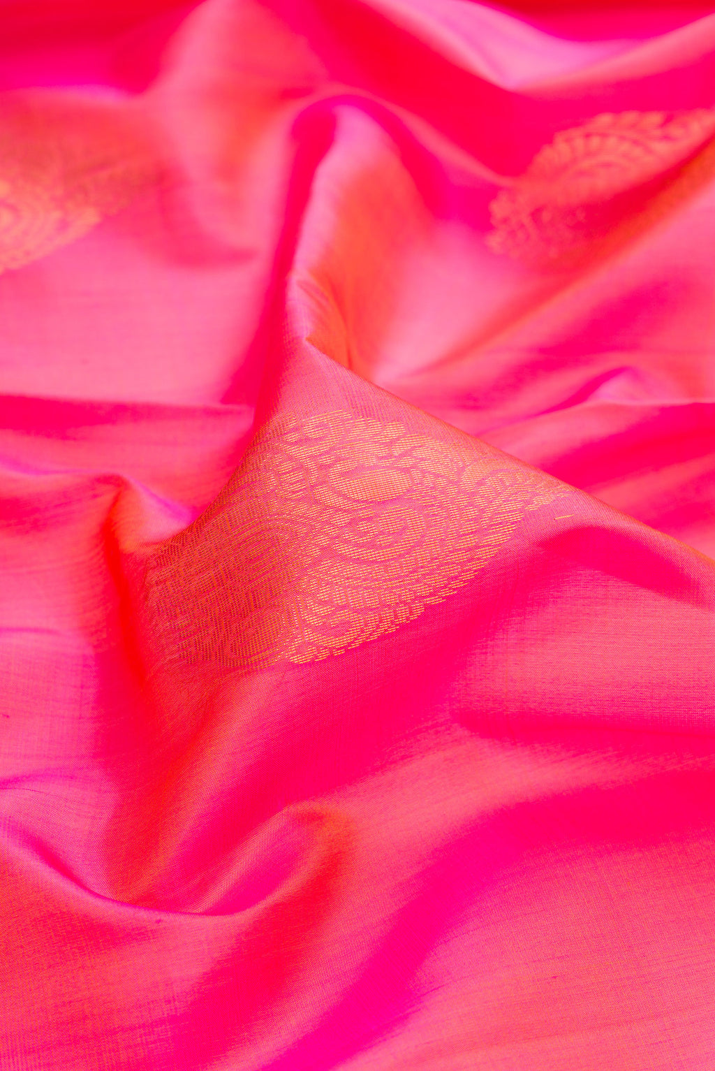 Close up of Pink Dual Tone Soft Silk Saree with Zari Butta on the body and Zari Border.  displaying folds