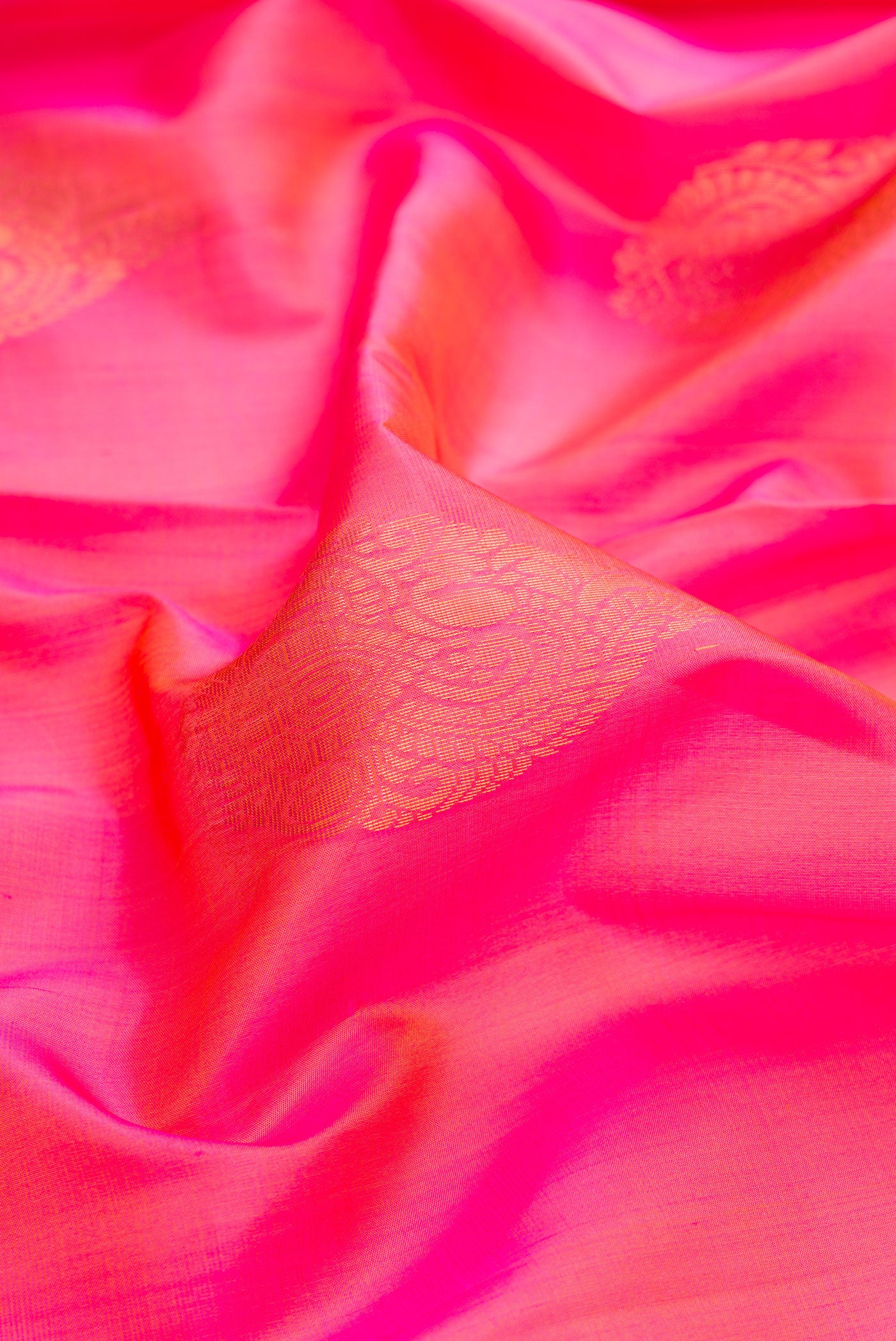 Close up of Pink Dual Tone Soft Silk Saree with Zari Butta on the body and Zari Border.  displaying folds