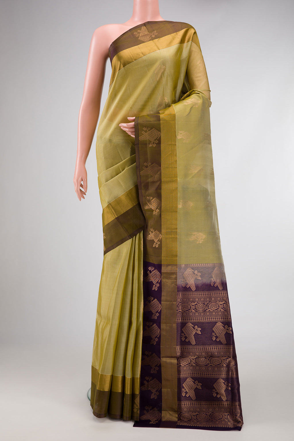 Mehandi Green Dual Tone Soft Silk Saree with Zari Butta on the body and Zari Border.  displayed on a mannequin