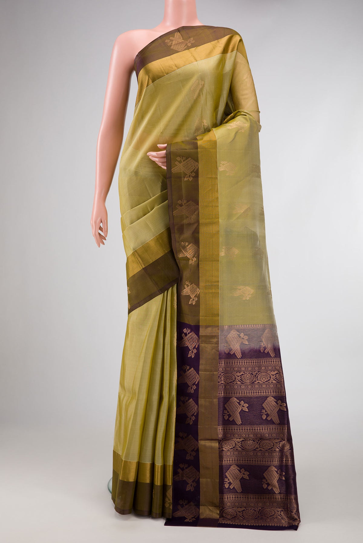 Mehandi Green Dual Tone Soft Silk Saree with Zari Butta on the body and Zari Border.  displayed on a mannequin