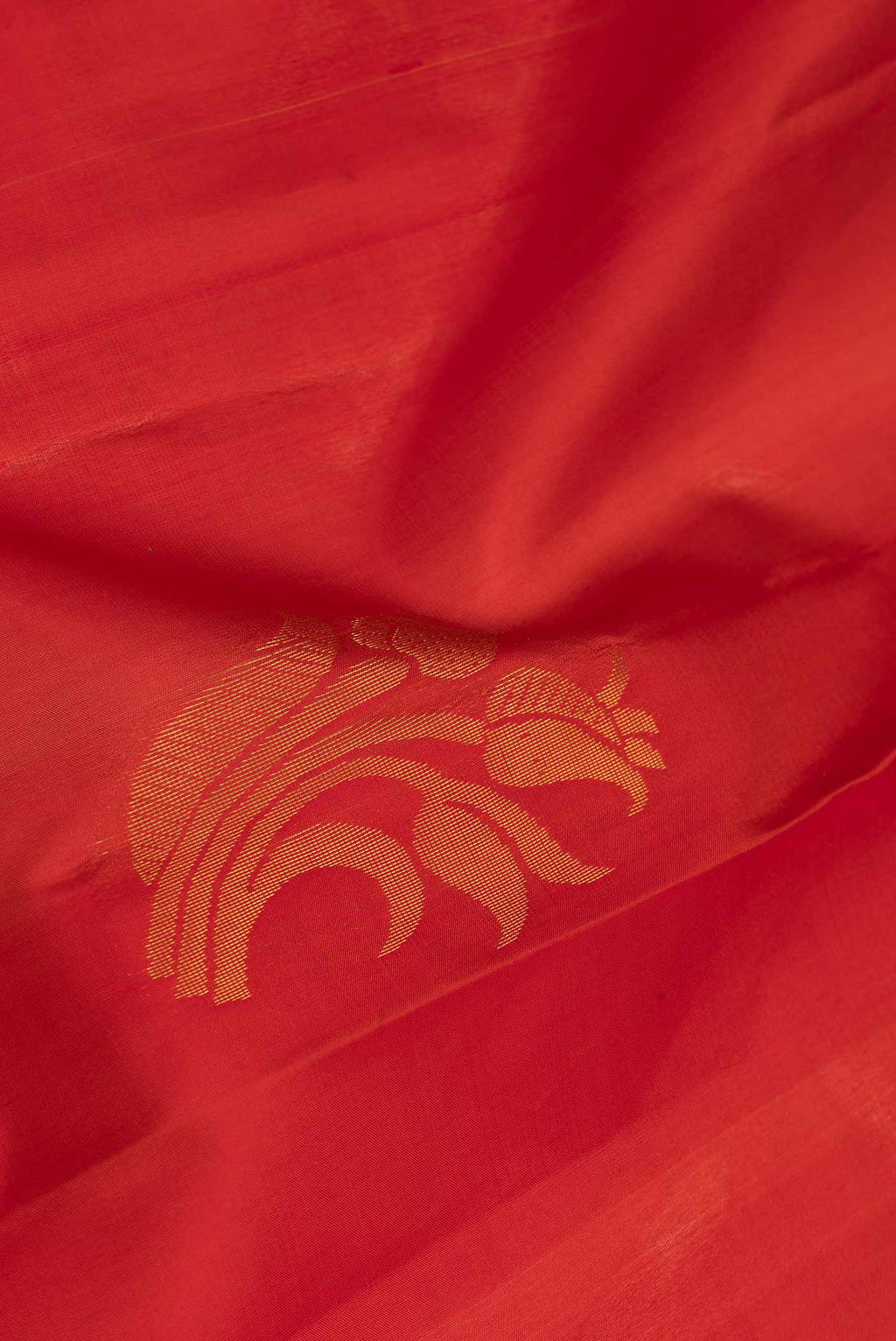 Close up of Red Dual Tone Soft Silk Saree with Zari Butta on the body and Zari Border.  displaying folds