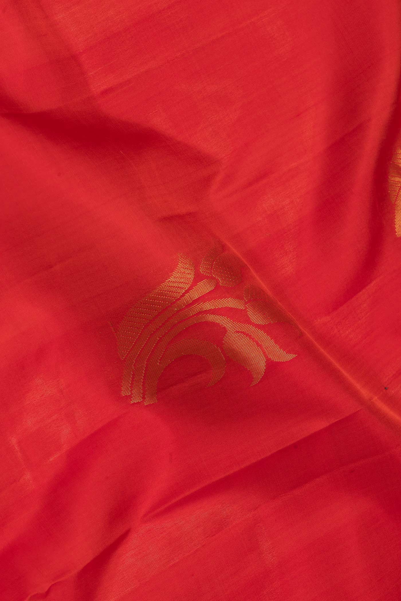 Close up of Red Dual Tone Soft Silk Saree with Zari Butta on the body and Zari Border.  displaying folds