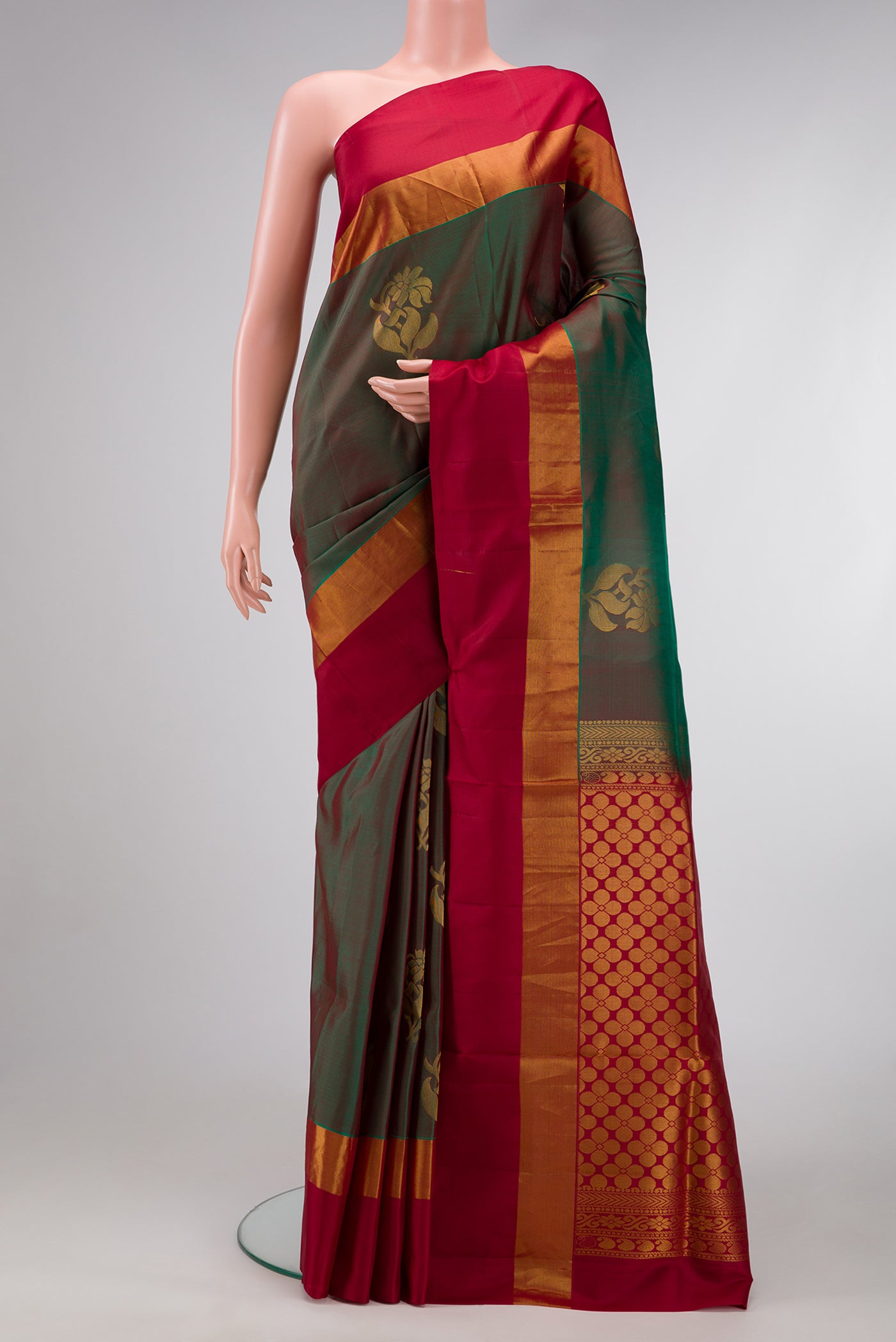 Green Dual Tone Soft Silk Saree with Zari Butta on the body and Zari Border.  displayed on a mannequin