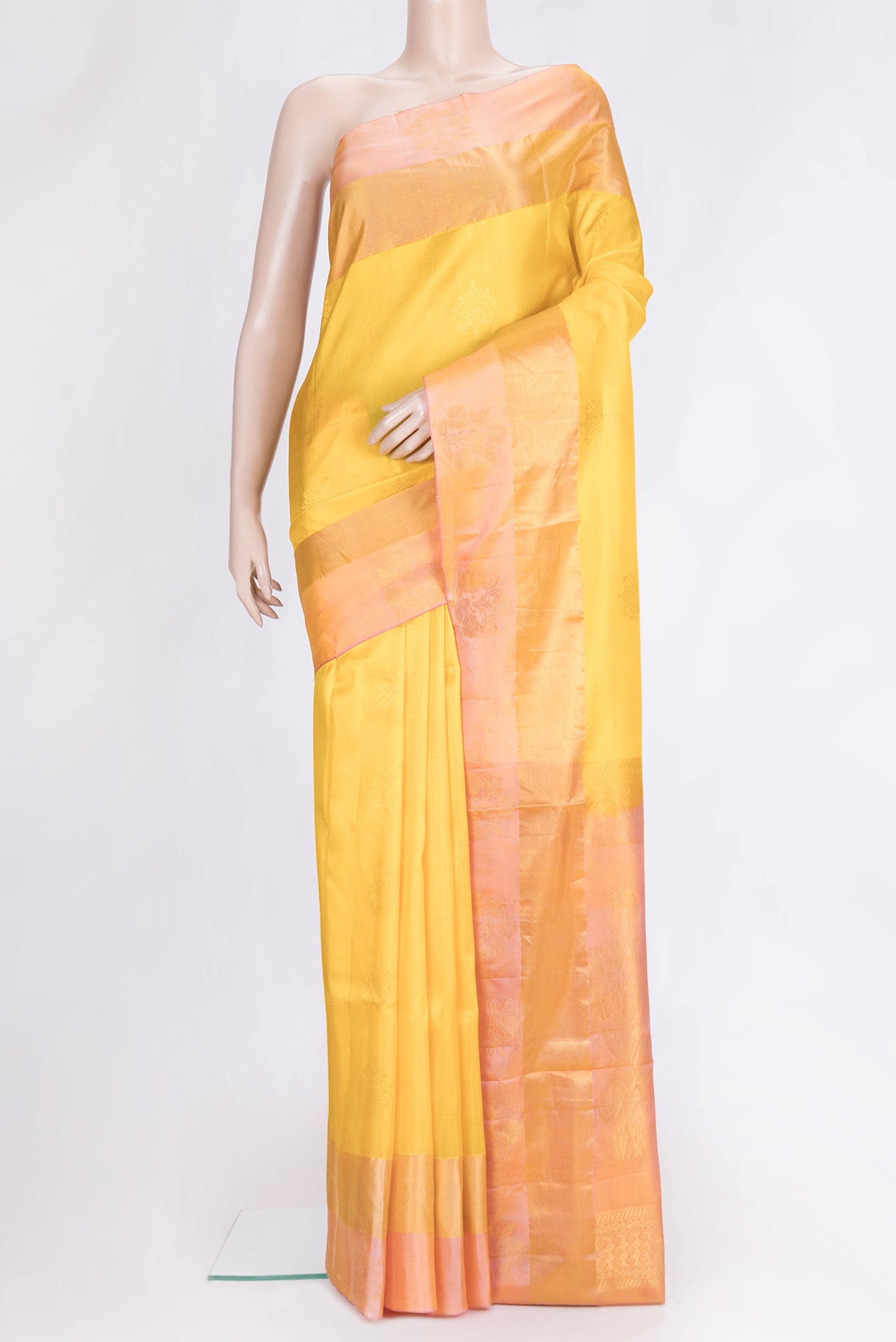 Yellow Dual Tone Soft Silk Saree with Zari Butta on the body and Fancy Border.  displayed on a mannequin