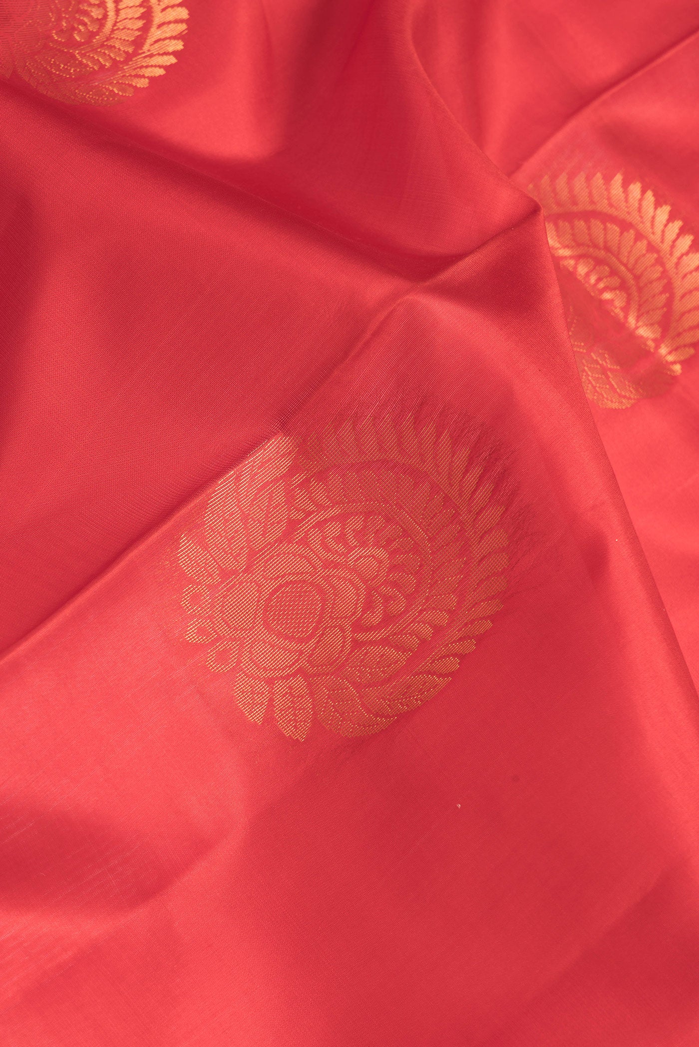 Close up of Red Dual Tone Soft Silk Saree with Zari Butta on the body and Zari Border.  displaying folds