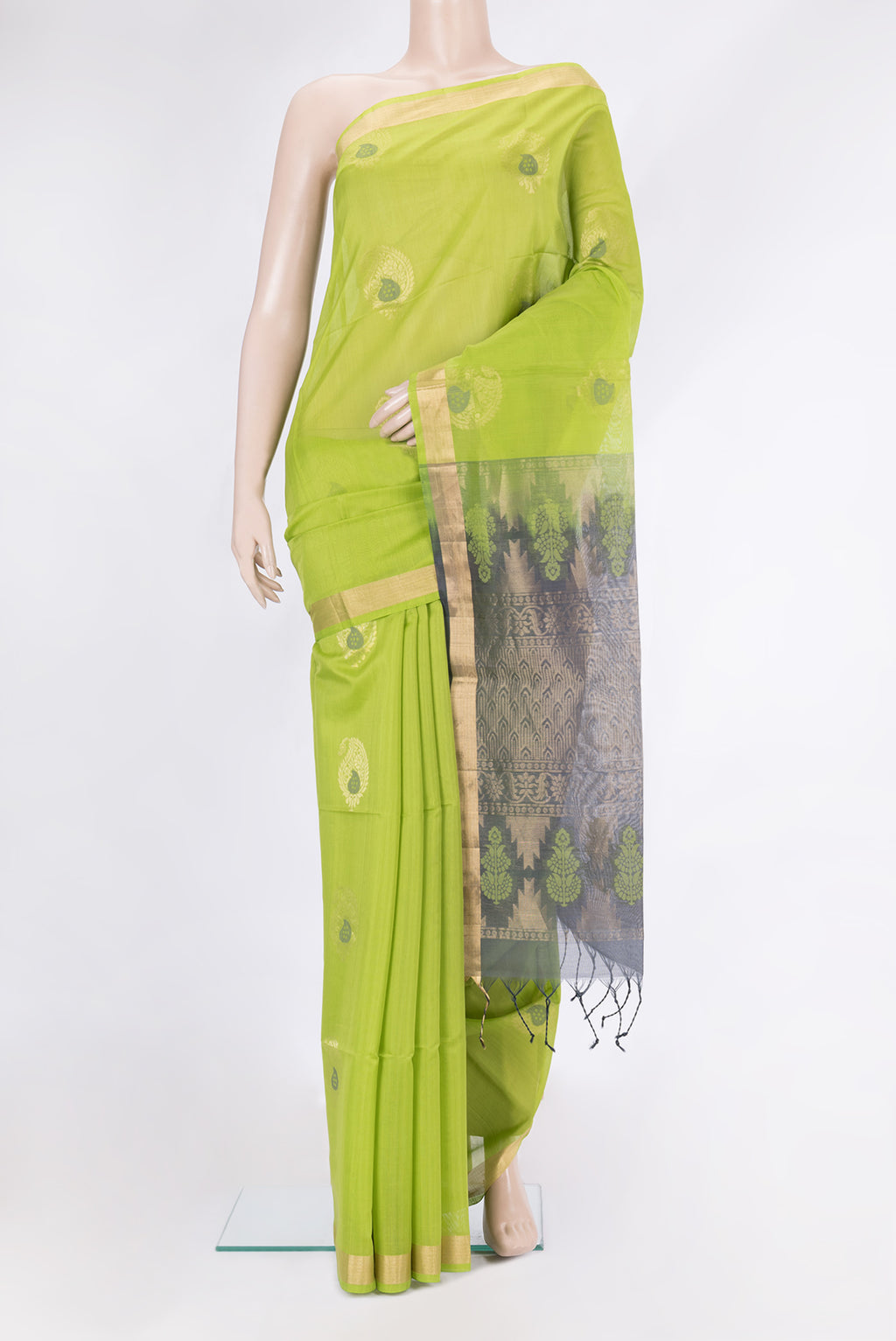 Parrot Green Silk Cotton Saree with Zari Butta on the body and Zari Border.  displayed on a mannequin