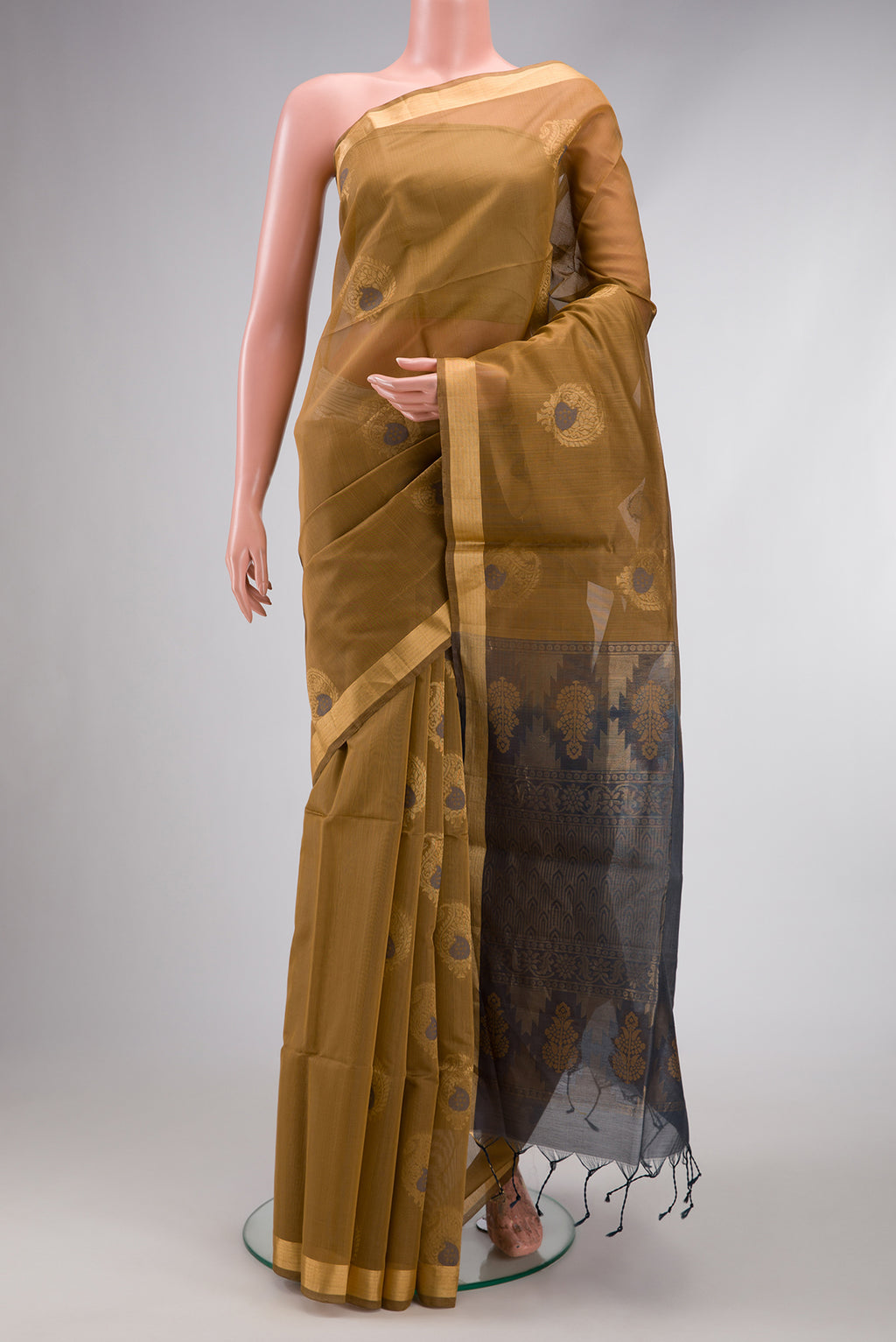 Brown Silk Cotton Saree with Zari And Thread Butta on the body and Zari Border.  displayed on a mannequin