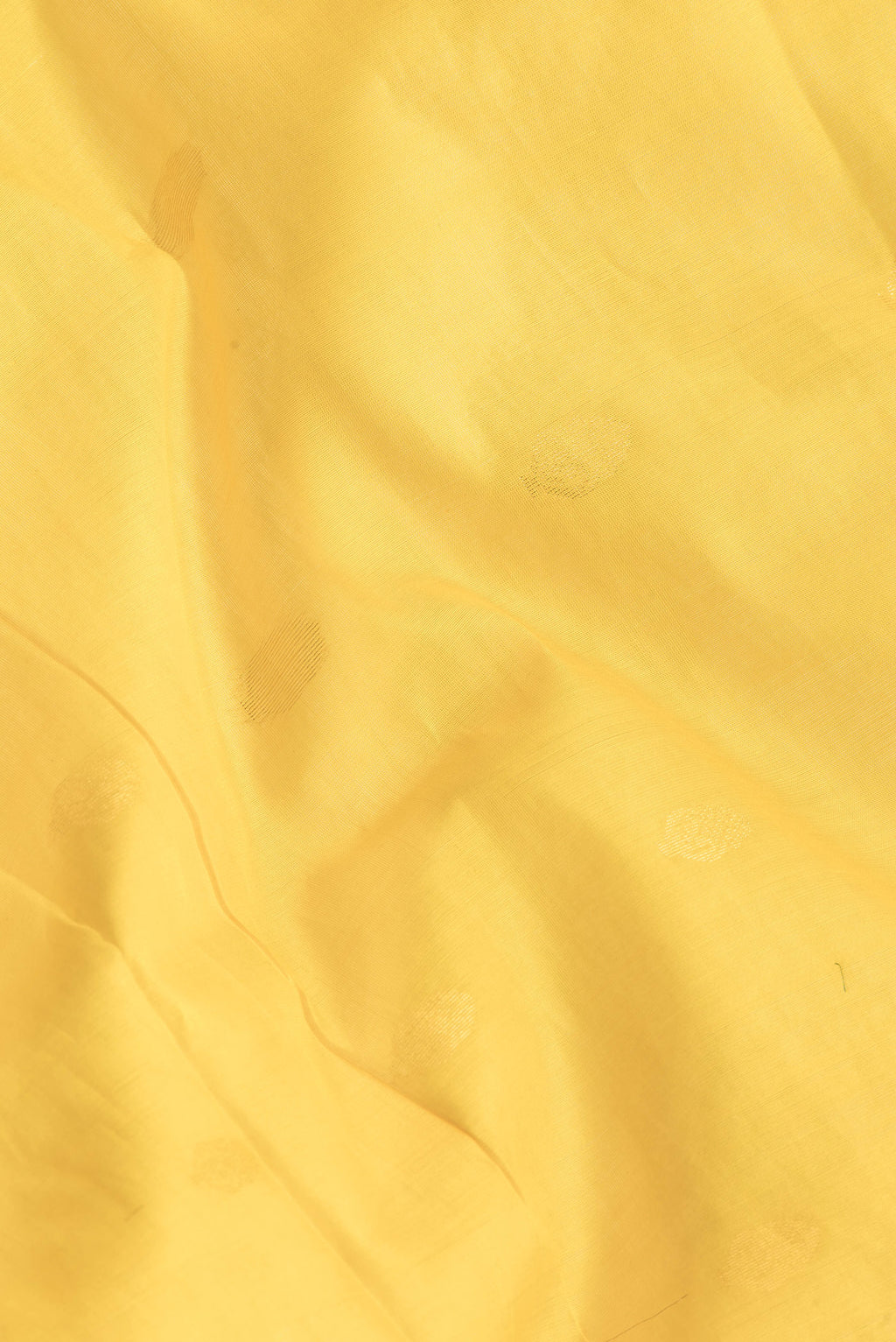 Close up of Yellow Dual Tone Silk Cotton Saree with Zari Butta on the body and Zari Border.  displaying folds