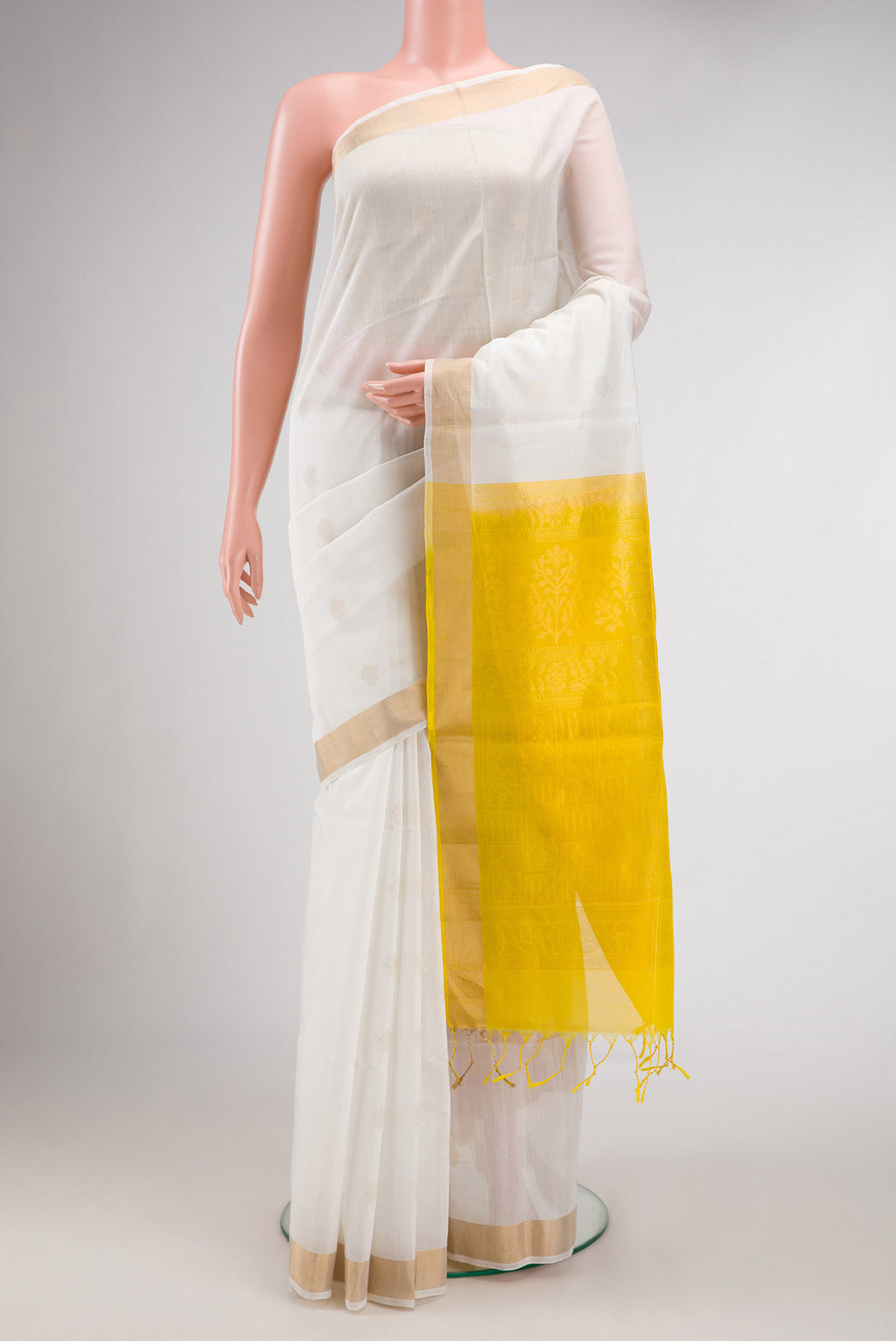 White Dual Tone Silk Cotton Saree with Zari Butta on the body and Zari Border.  displayed on a mannequin