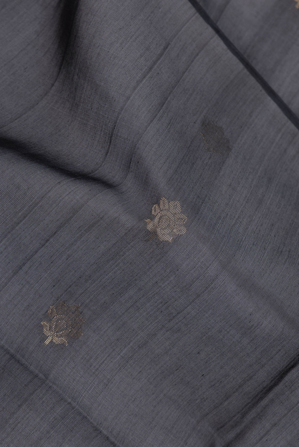 Close up of Black Silk Cotton Saree with Zari Butta on the body and Zari Border.  displaying folds