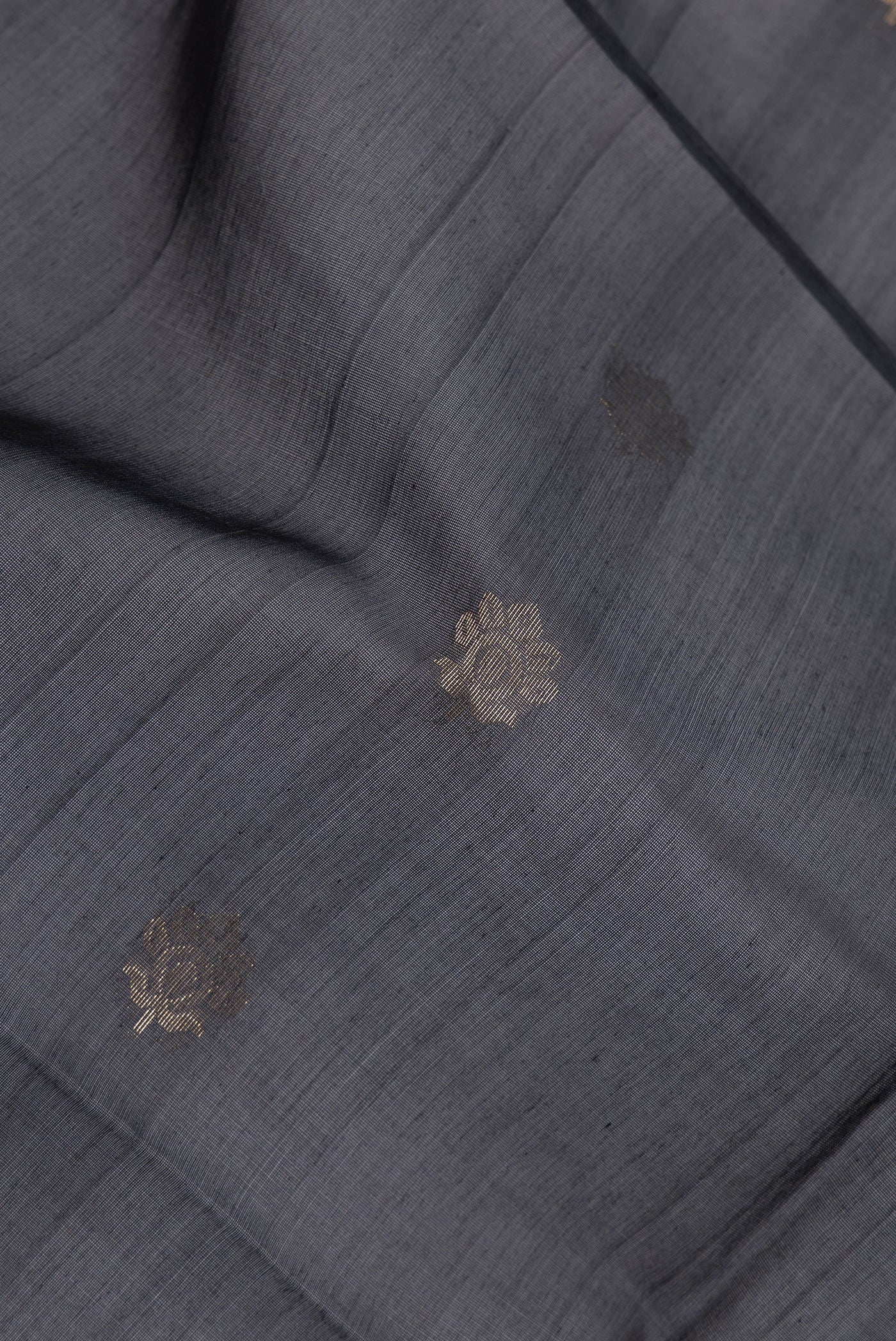 Close up of Black Silk Cotton Saree with Zari Butta on the body and Zari Border.  displaying folds