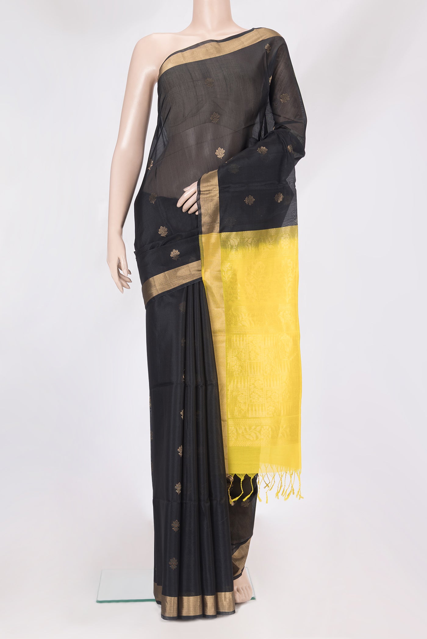 Black Silk Cotton Saree with Zari Butta on the body and Zari Border.  displayed on a mannequin